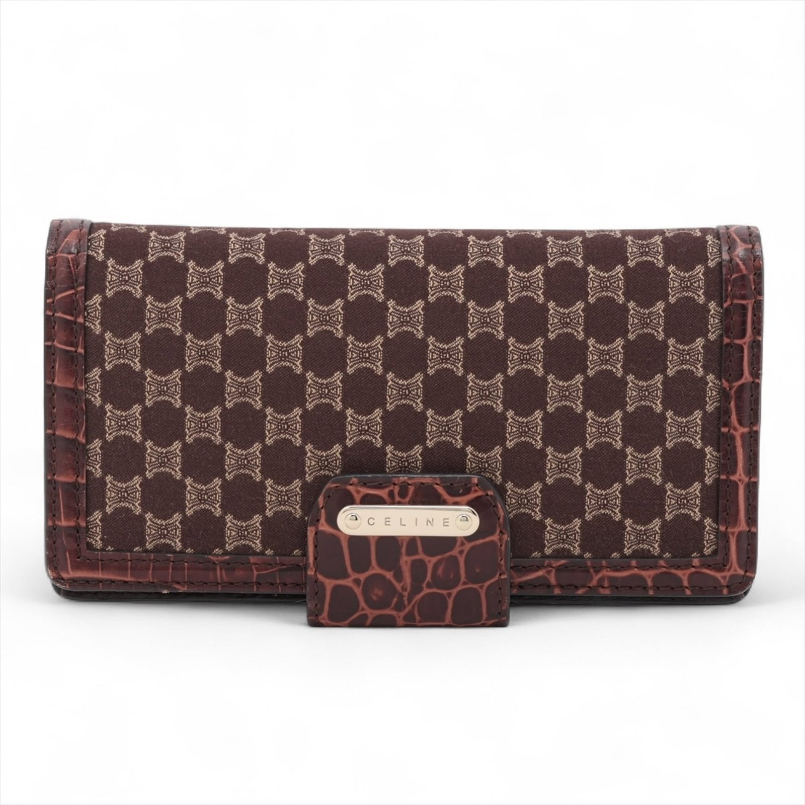 Celine Long Bi-Fold Wallet: Celine Long Bi-Fold Wallet A timeless piece from the iconic Celine brand, this long bi-fold wallet boasts a rich brown leather exterior and a classic design that exudes sophistication. With its sturdy