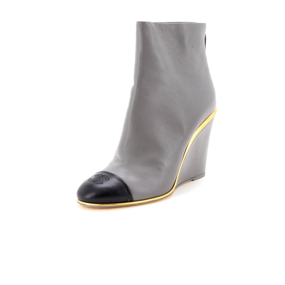 Chanel Women's CC Cap-Toe Wedge Ankle Boots in Leather: Chanel Women's CC Cap-Toe Wedge Ankle Boots in Leather Elevate your shoe game with the iconic Chanel Women's CC Cap-Toe Wedge Ankle Boots, boasting sleek cap-toe design and a sturdy wedge heel that ad