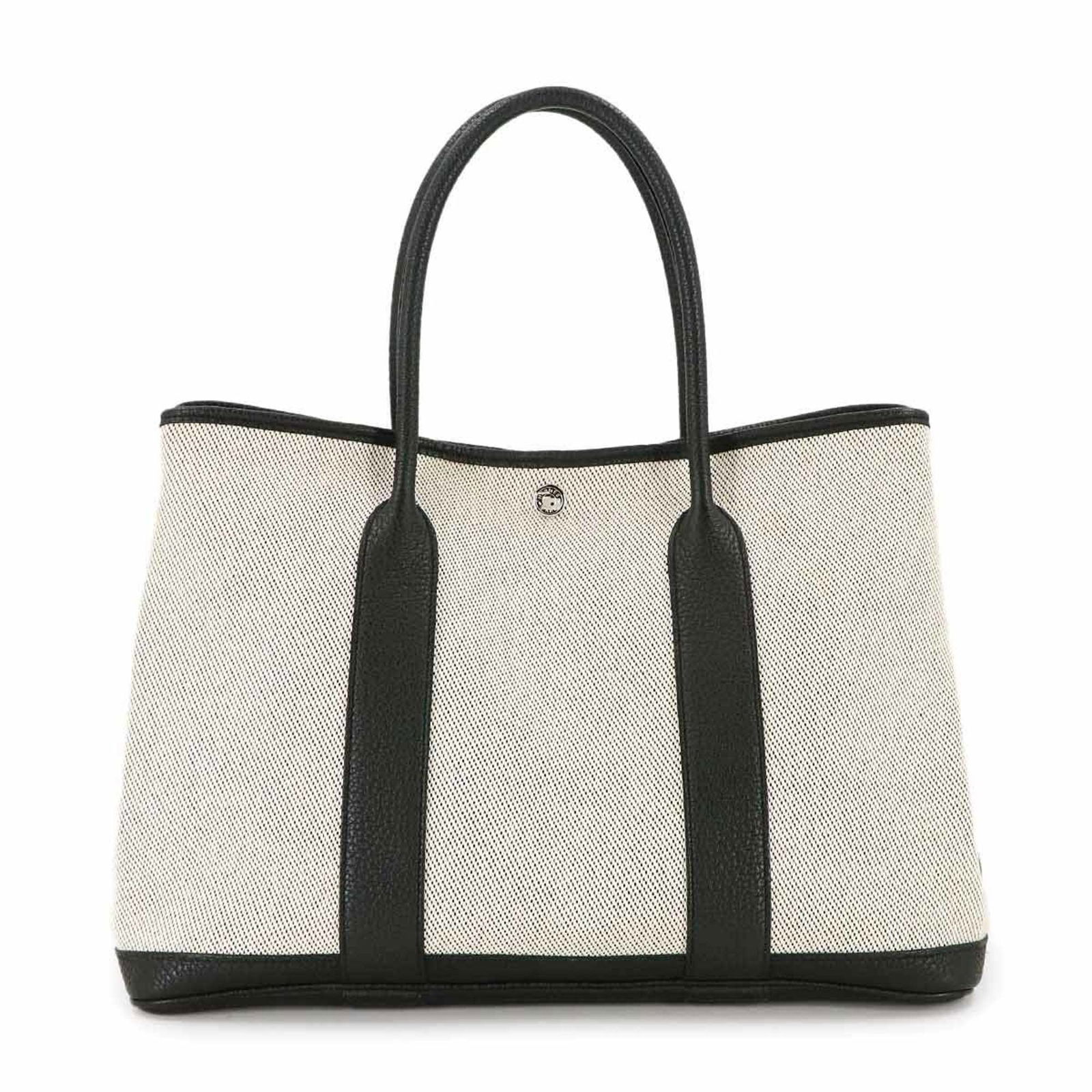 Tote Bag Negonda Leather - Hermes Handbag: Tote Bag Negonda Leather - Hermes Handbag Experience the timeless elegance of an authentic Hermes tote bag, crafted from rich Negonda leather in sleek black and ecru hues. With its classic 26cm x 36cm