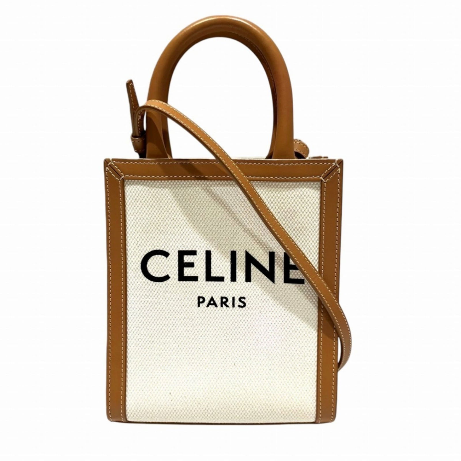 Celine Canvas and Leather Shoulder Bag: Celine Canvas and Leather Shoulder Bag A timeless piece from the iconic Celine brand, this canvas and leather shoulder bag boasts a chic brown and ivory color combination that exudes effortless