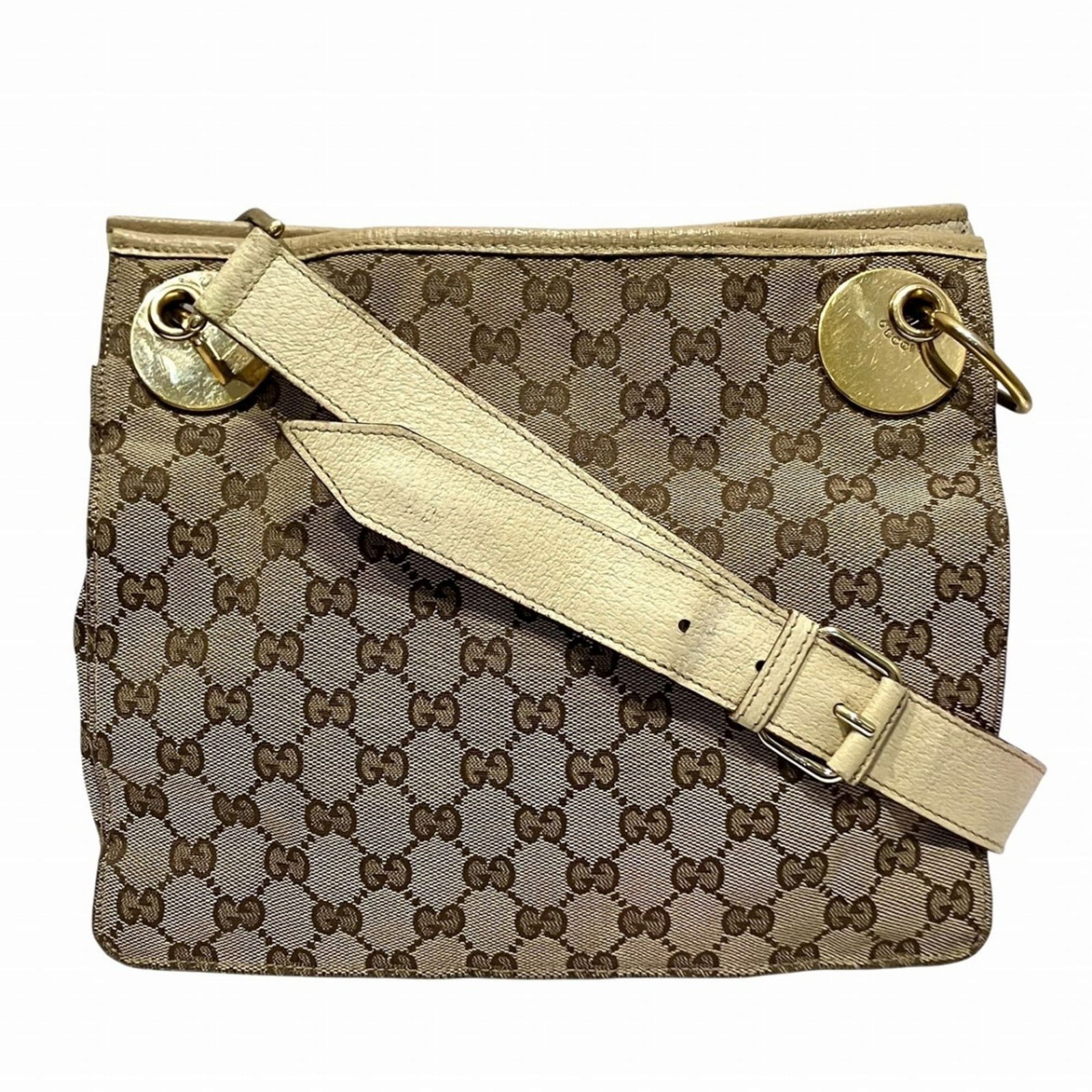 Gucci Canvas and Leather Shoulder Bag: Gucci Canvas and Leather Shoulder Bag A stylish Gucci shoulder bag, perfect for everyday use, boasts a unique canvas and leather combination in a timeless beige hue. With its spacious interior and com