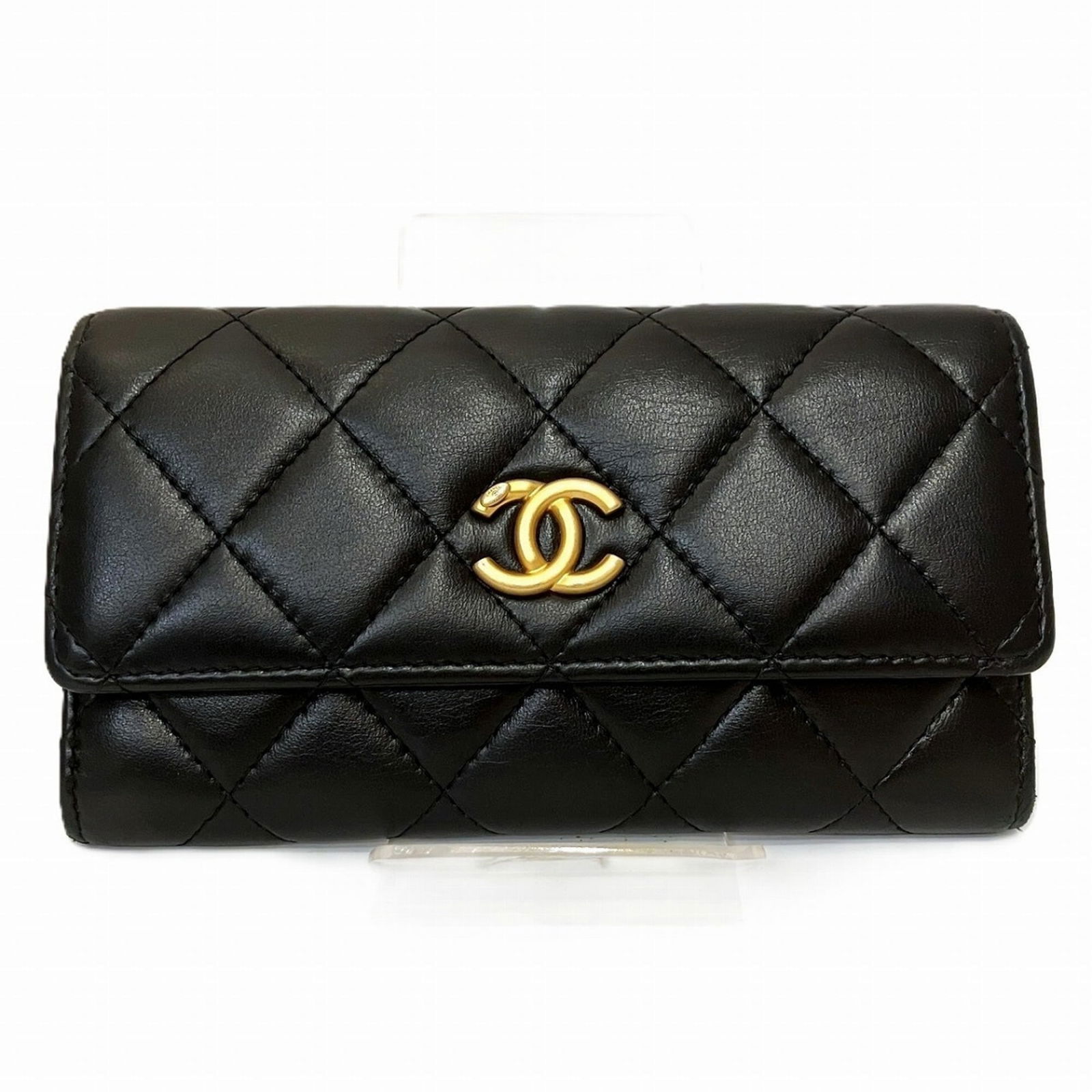 Chanel Bi-Fold Leather Wallet: Chanel Bi-Fold Leather Wallet A timeless piece of luxury, this Chanel bi-fold leather wallet boasts sleek black lambskin and classic design, perfect for adding an air of sophistication to any outfit.