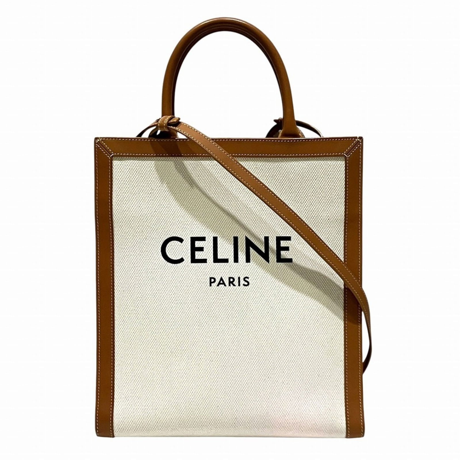 Celine Canvas and Leather Tote Bag: Celine Canvas and Leather Tote Bag A timeless and sophisticated Celine tote bag, crafted from high-quality canvas and leather, boasts a sleek white finish that exudes effortless elegance. With its cla