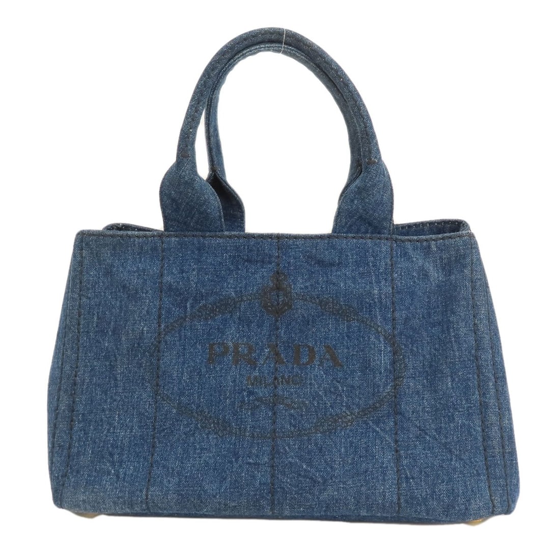 Prada B1877B Canapa Tote Bag in Denim: Prada B1877B Canapa Tote Bag in Denim A timeless denim tote from Prada, the B1877B Canapa is a versatile and stylish addition to any wardrobe. Crafted with high-quality denim, this bag boasts a
