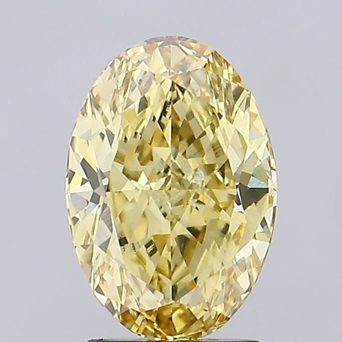 IGI Oval 2.19ct Fancy Vivid Yellow VVS2 Diamond: IGI Oval 2.19ct Fancy Vivid Yellow VVS2 Diamond Experience the vibrant beauty of nature with this stunning 2.19ct Fancy Vivid Yellow VVS2 diamond, certified by the International Gemological Institute