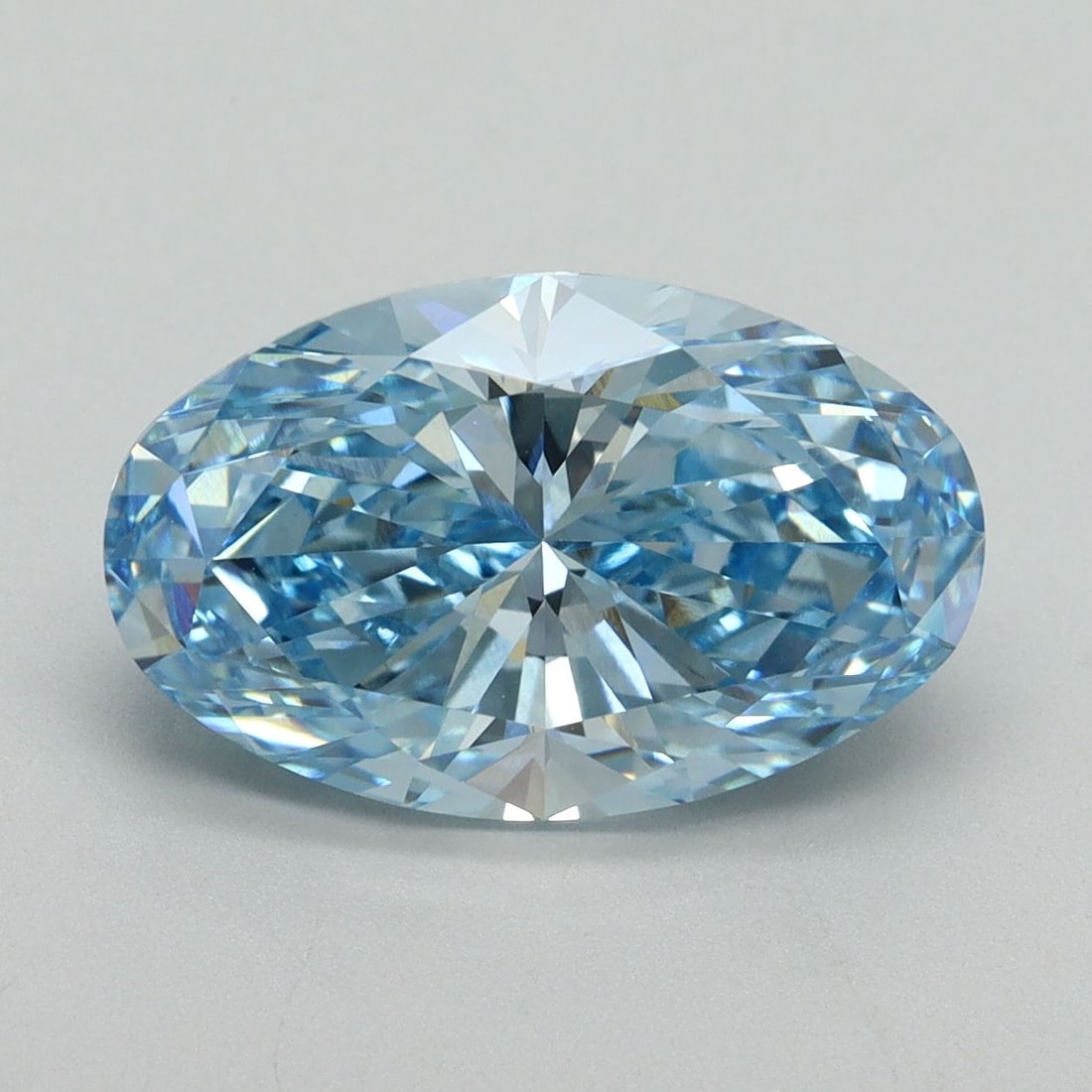 IGI Oval 4.11ct Fancy Vivid Blue VVS2 Loose Lab Diamond: IGI Oval 4.11ct Fancy Vivid Blue VVS2 Loose Lab Diamond Experience the rare beauty of a Fancy Vivid Blue diamond, one of the most coveted colors in the world of gemstones. This 4.11ct lab-grown IGI ce