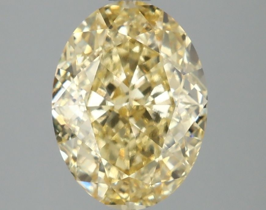 IGI Oval 3.04ct Fancy Vivid Yellow VVS2 Diamond: IGI Oval 3.04ct Fancy Vivid Yellow VVS2 Diamond A stunning Fancy Vivid Yellow diamond, certified by the International Gemological Institute (IGI), boasts exceptional clarity and cut quality, with an E