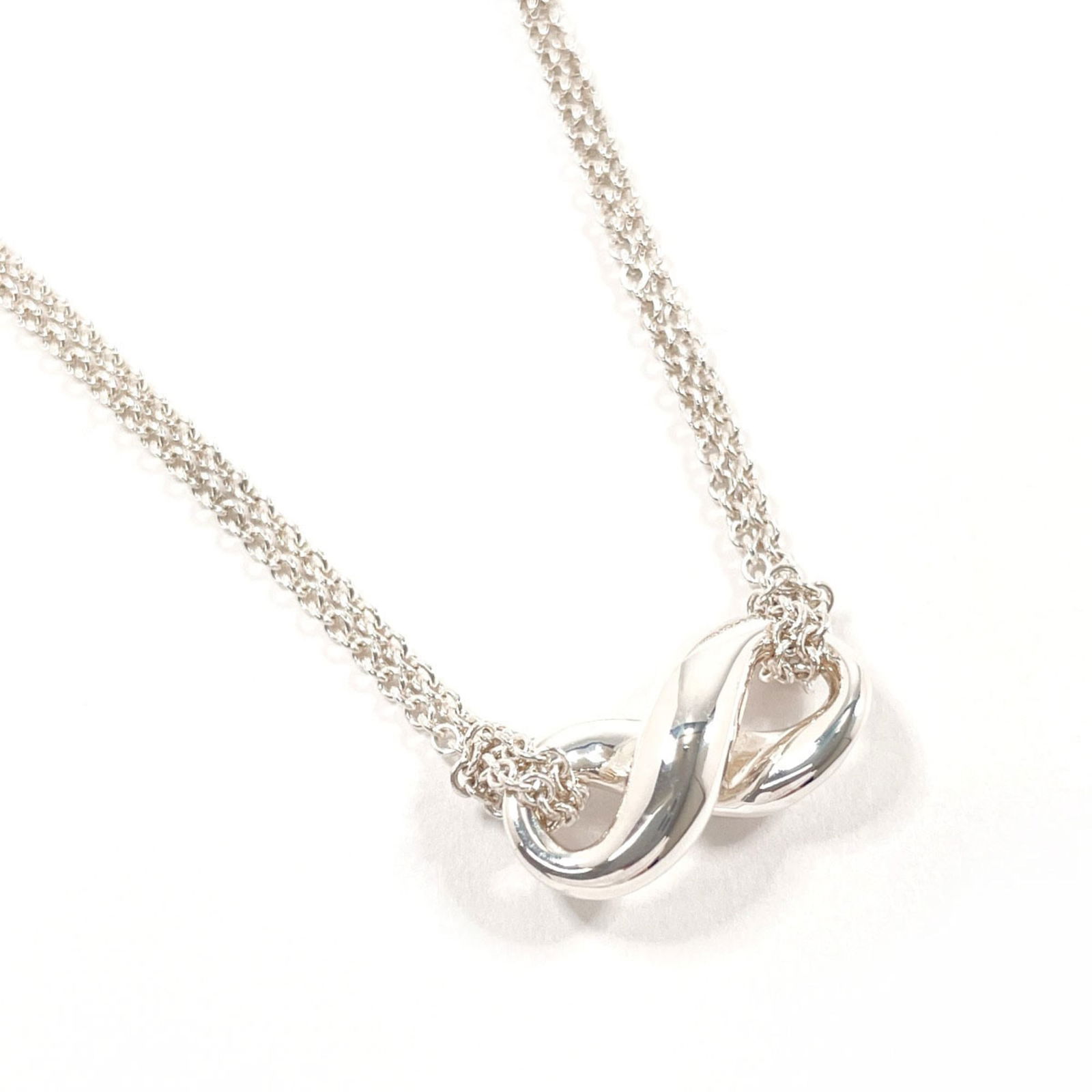 Tiffany & Co. Sterling Silver 925 Infinity Necklace for Women: Tiffany & Co. Sterling Silver 925 Infinity Necklace for Women Elevate your everyday style with the timeless elegance of Tiffany & Co.'s sterling silver 925 Infinity Necklace, expertly crafted to creat