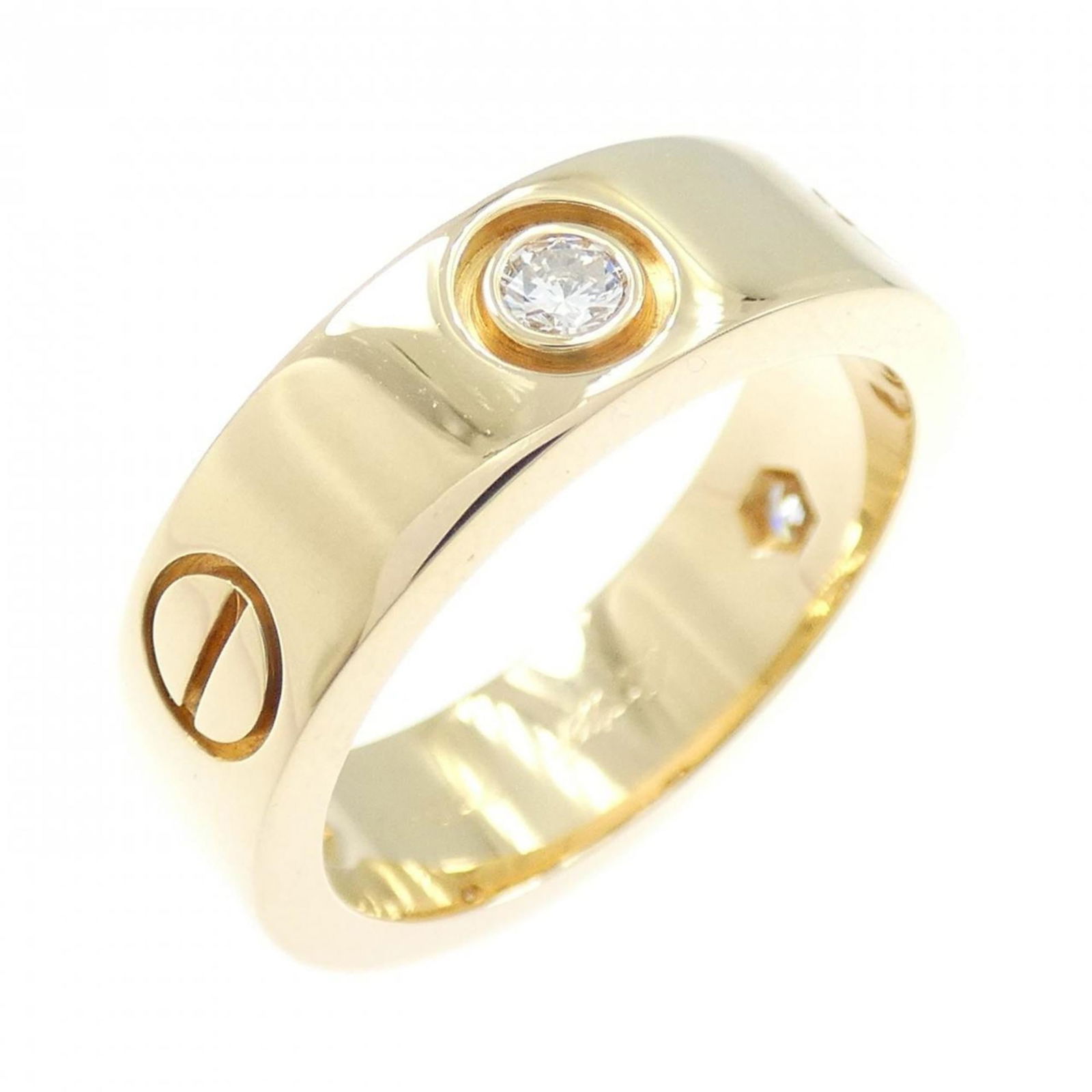 Cartier 18k Yellow Gold Band Ring: Cartier 18k Yellow Gold Band Ring A stunning Cartier band ring in 18k yellow gold, adorned with a diamond, adds a touch of timeless elegance to any outfit. With its classic design and high-quality cra