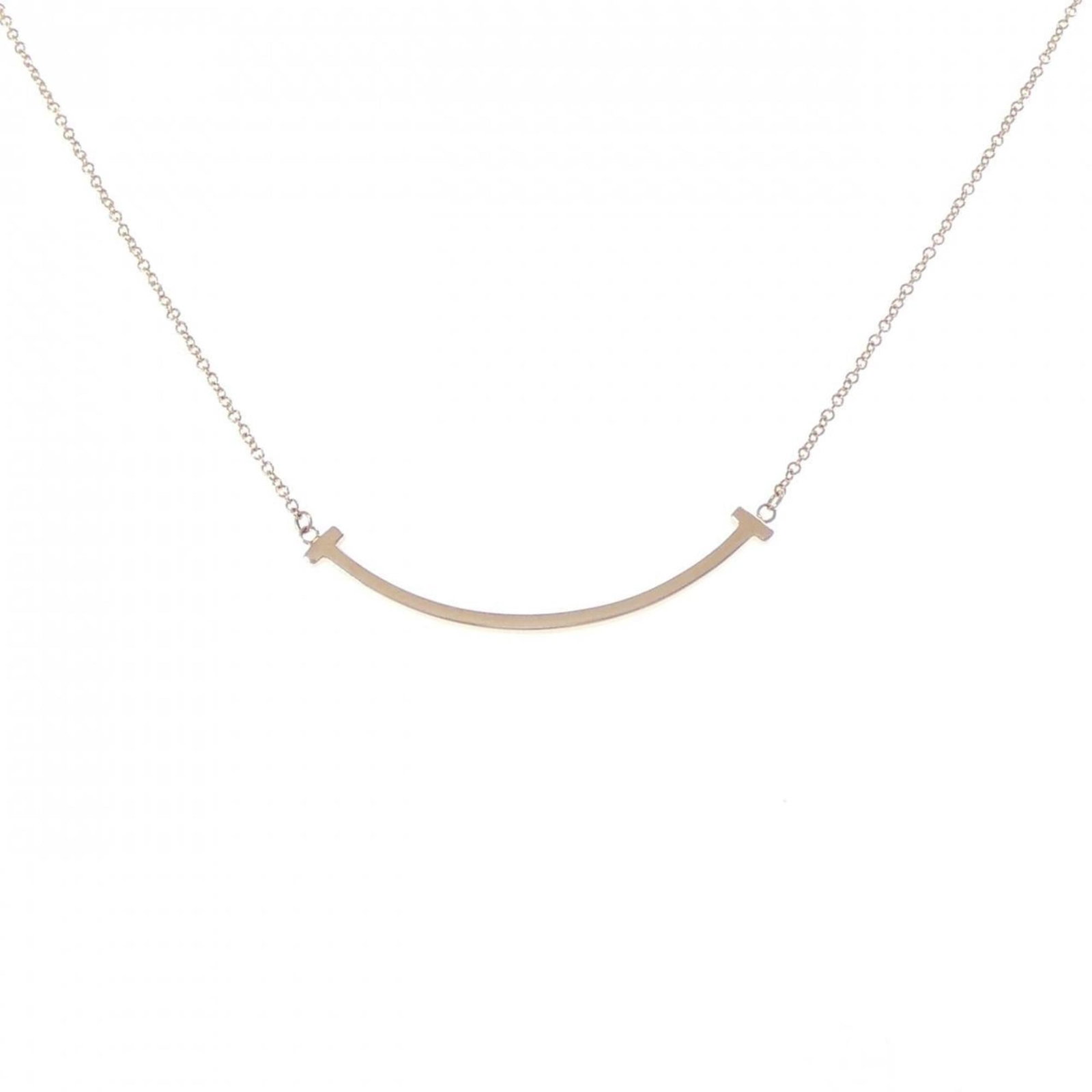 Necklace Tiffany T Smile Small: Necklace Tiffany T Smile Small Elevate your style with the iconic Tiffany T Smile Small necklace, crafted from 18K pink gold and boasting a delicate 3.7mm x 36.5mm pendant that adds a touch of sophist