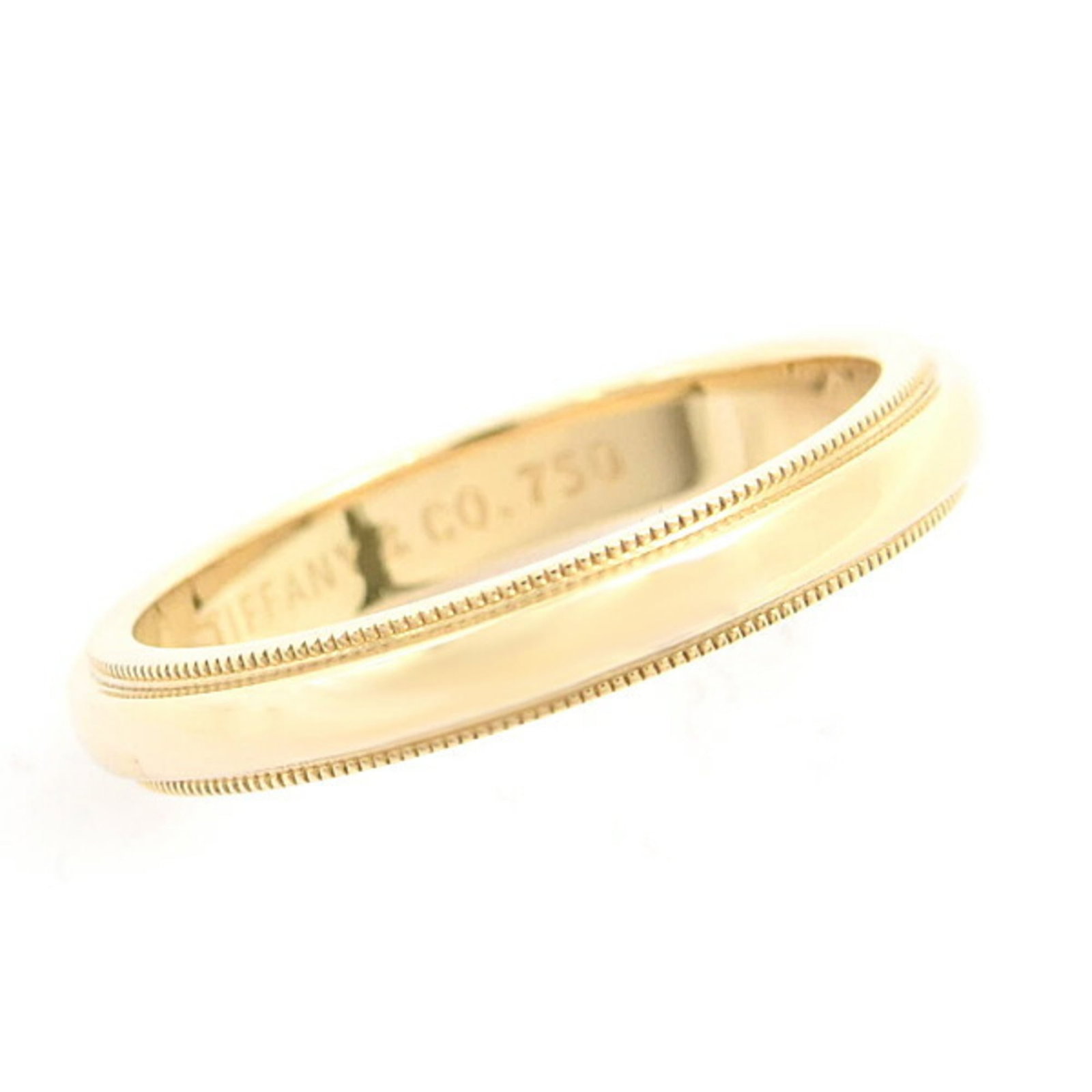 (18K) Tiffany Band Ring Yellow Gold: (18K) Tiffany Band Ring Yellow Gold A beautiful piece of Tiffany history, this 18K yellow gold band ring boasts the iconic brand's signature craftsmanship and style. With its elegant design and high-q
