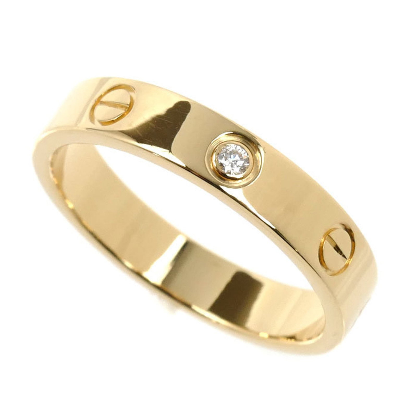 Cartier 18k Yellow Gold Band Ring: Cartier 18k Yellow Gold Band Ring A stunning Cartier band ring in 18k yellow gold, adorned with a diamond stone, adds a touch of elegance to any outfit. With its classic design and high-quality materi