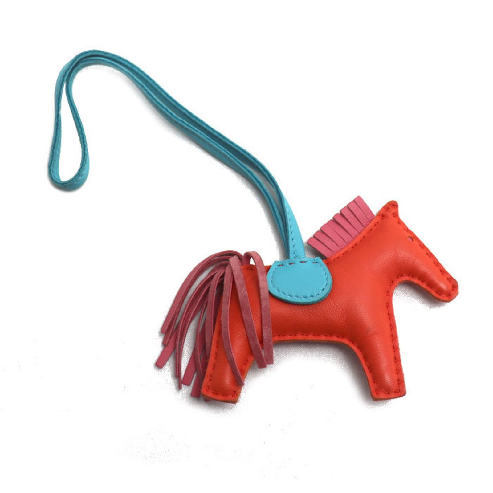 Hermes Agneau Milo Handbag Charm: Hermes Agneau Milo Handbag Charm A rare opportunity to own a piece of luxury, the Hermes Agneau Milo Handbag Charm is a stunning accessory that adds a touch of elegance to any outfit. Made from high-q