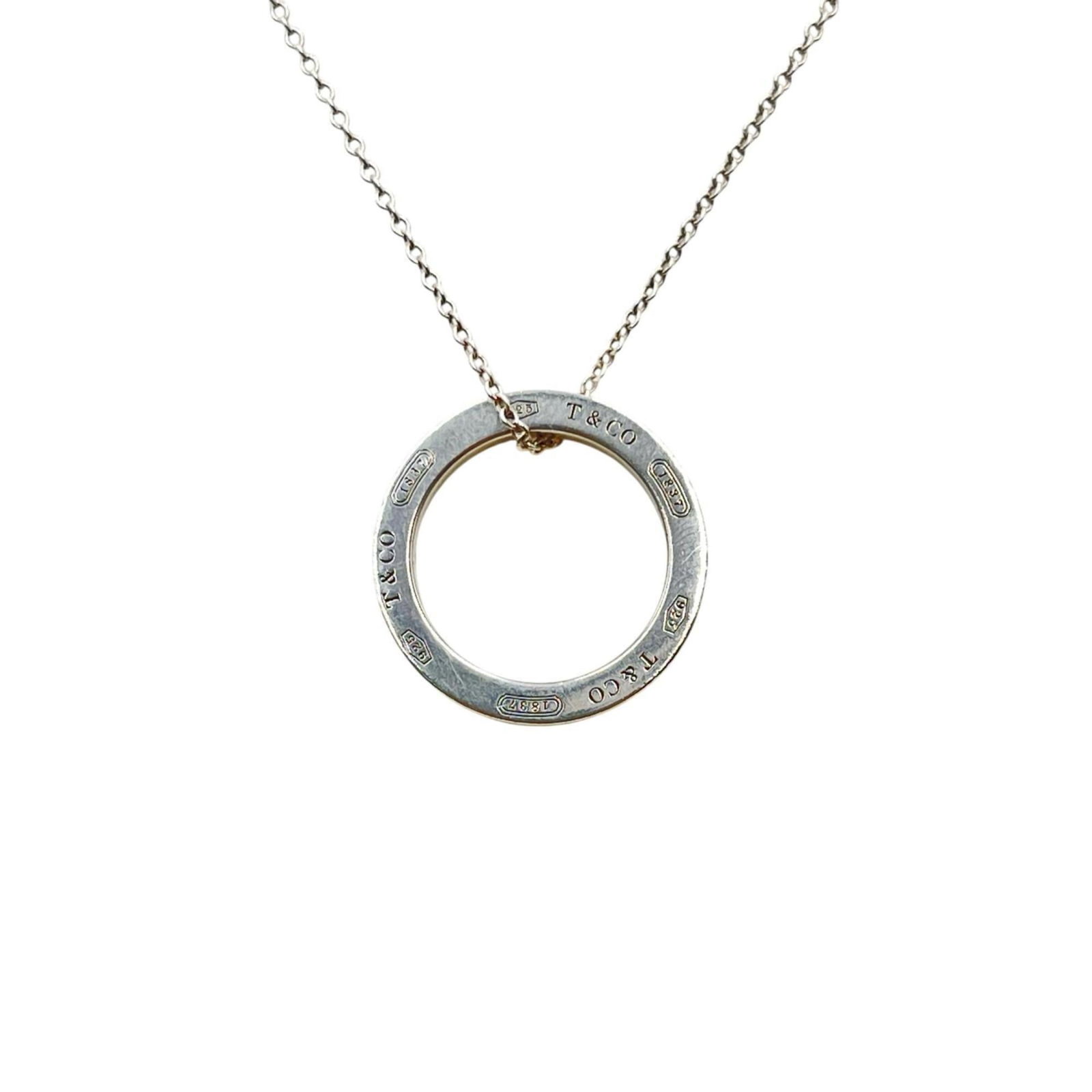 Tiffany & Co. 1837 Circle Necklace in Sterling Silver 925 for Women: Tiffany & Co. 1837 Circle Necklace in Sterling Silver 925 for Women Experience timeless elegance with the iconic Tiffany & Co. 1837 Circle Necklace, crafted from sterling silver 925 for women. This cl