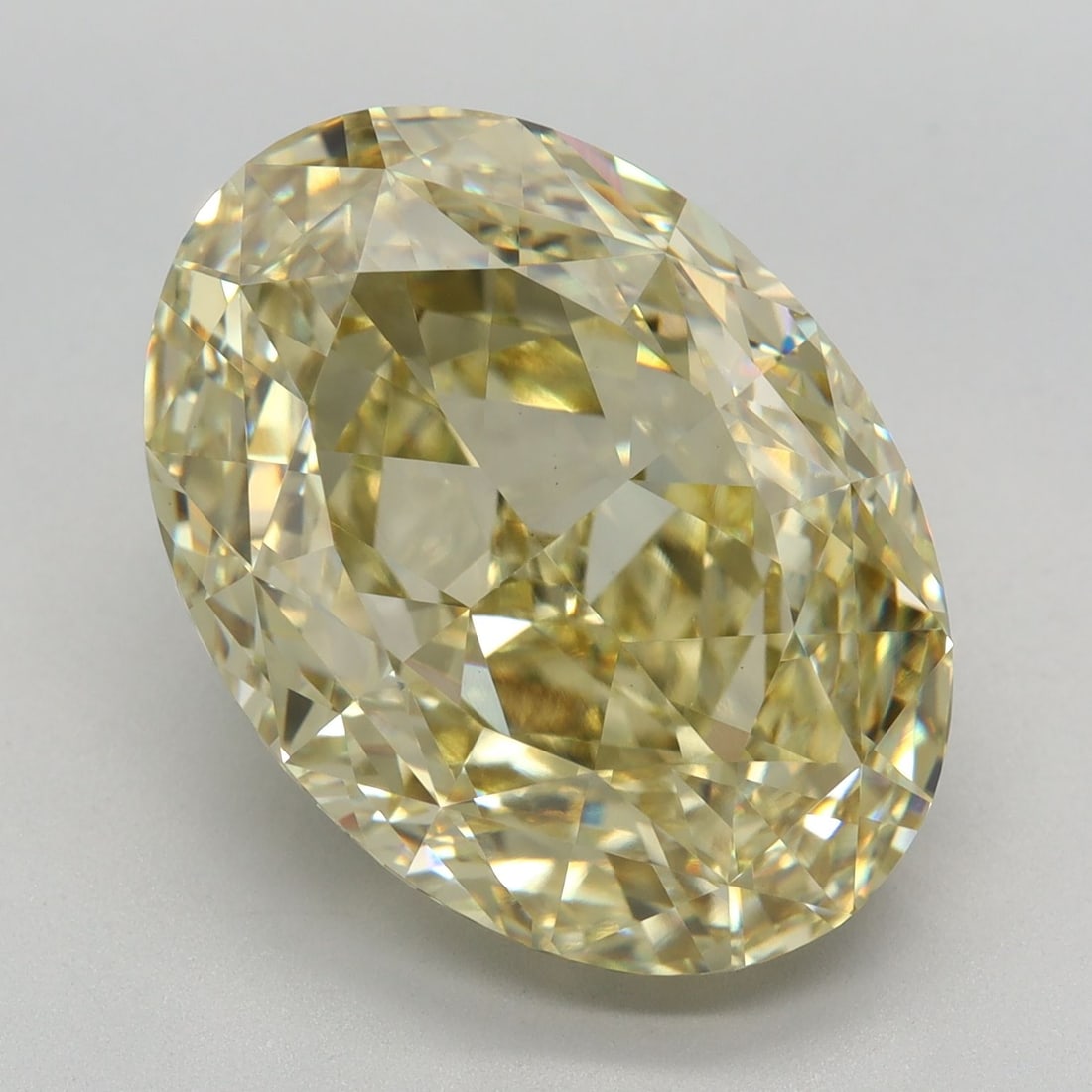IGI Oval 10.65ct Fancy Yellow VVS2 Loose Lab Diamond: IGI Oval 10.65ct Fancy Yellow VVS2 Loose Lab Diamond Experience the vibrant beauty of a lab-grown Fancy Yellow diamond, certified by the International Gemological Institute (IGI) as VVS2 clarity and E