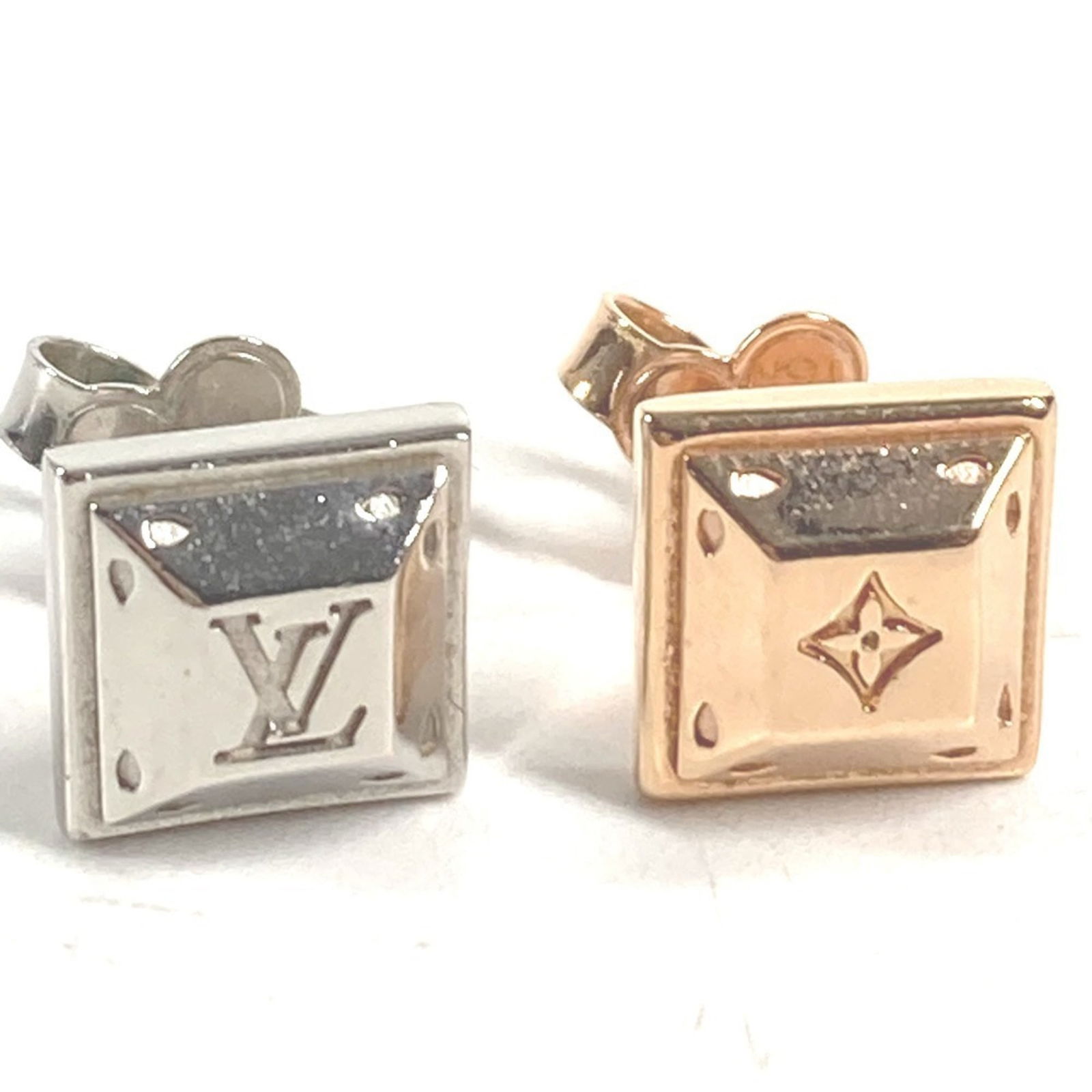 Louis Vuitton Stud Earrings in Metal: Louis Vuitton Stud Earrings in Metal Elevate your style with these iconic Louis Vuitton stud earrings, crafted in pink gold metal and boasting the signature LV monogram pattern. With their sleek, unde