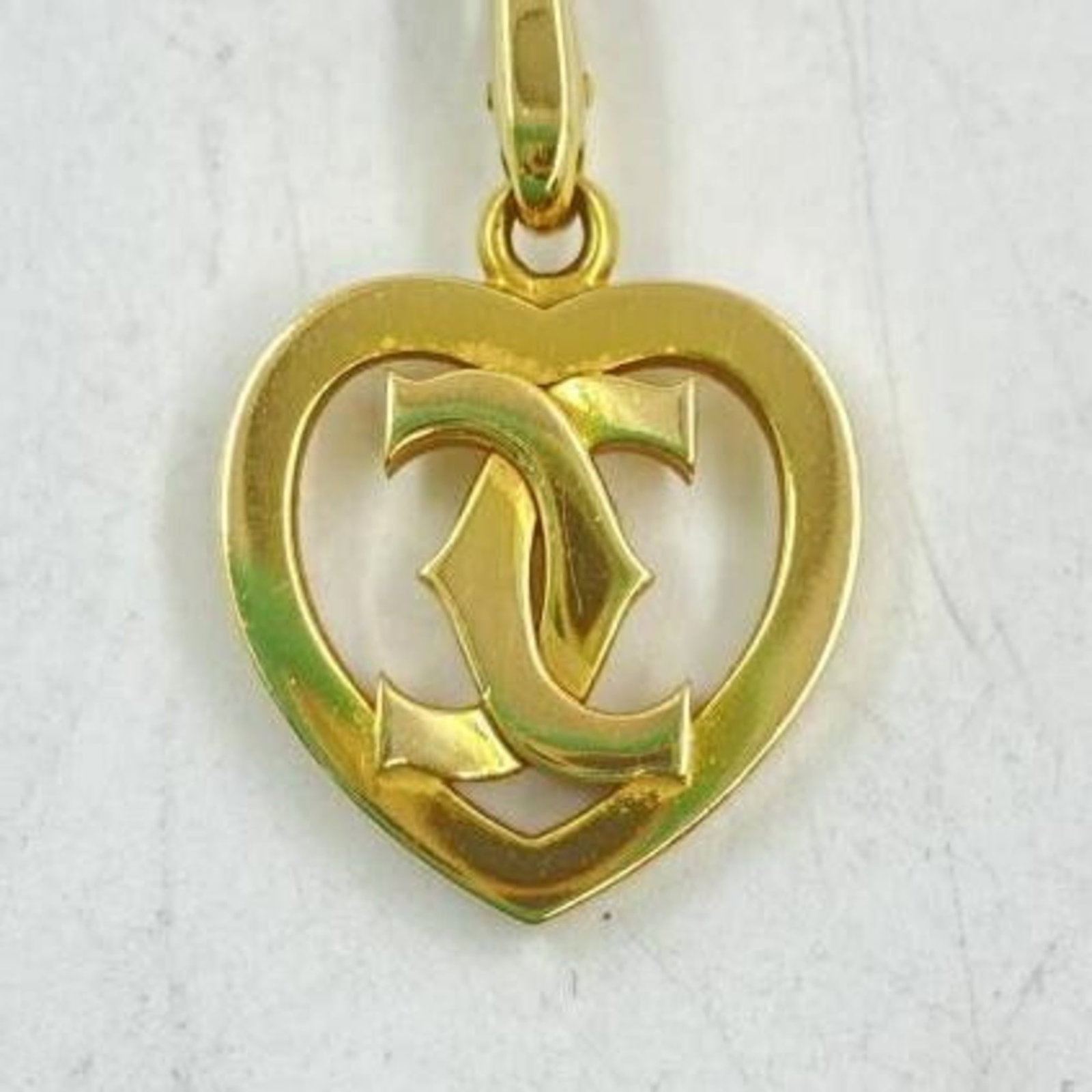 Necklace Cartier 2C Heart Charm: Necklace Cartier 2C Heart Charm A timeless piece of Cartier elegance, this 2C Heart Charm necklace boasts classic design and sophistication with its gold finish and iconic heart shape. With a comforta