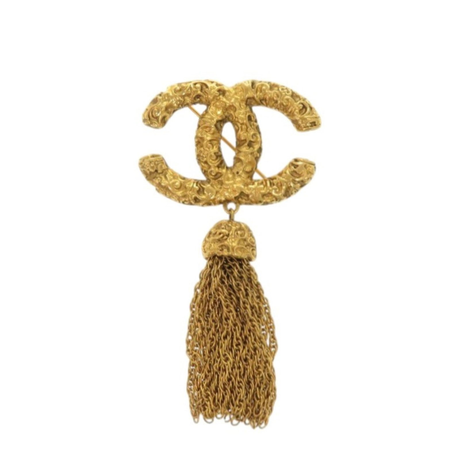 Chanel Brooch in Metal: Chanel Brooch in Metal A stunning Chanel brooch in gold metal, with its sleek design and luxurious feel, is sure to add a touch of elegance to any outfit. With only minor signs of wear, this pre-owned