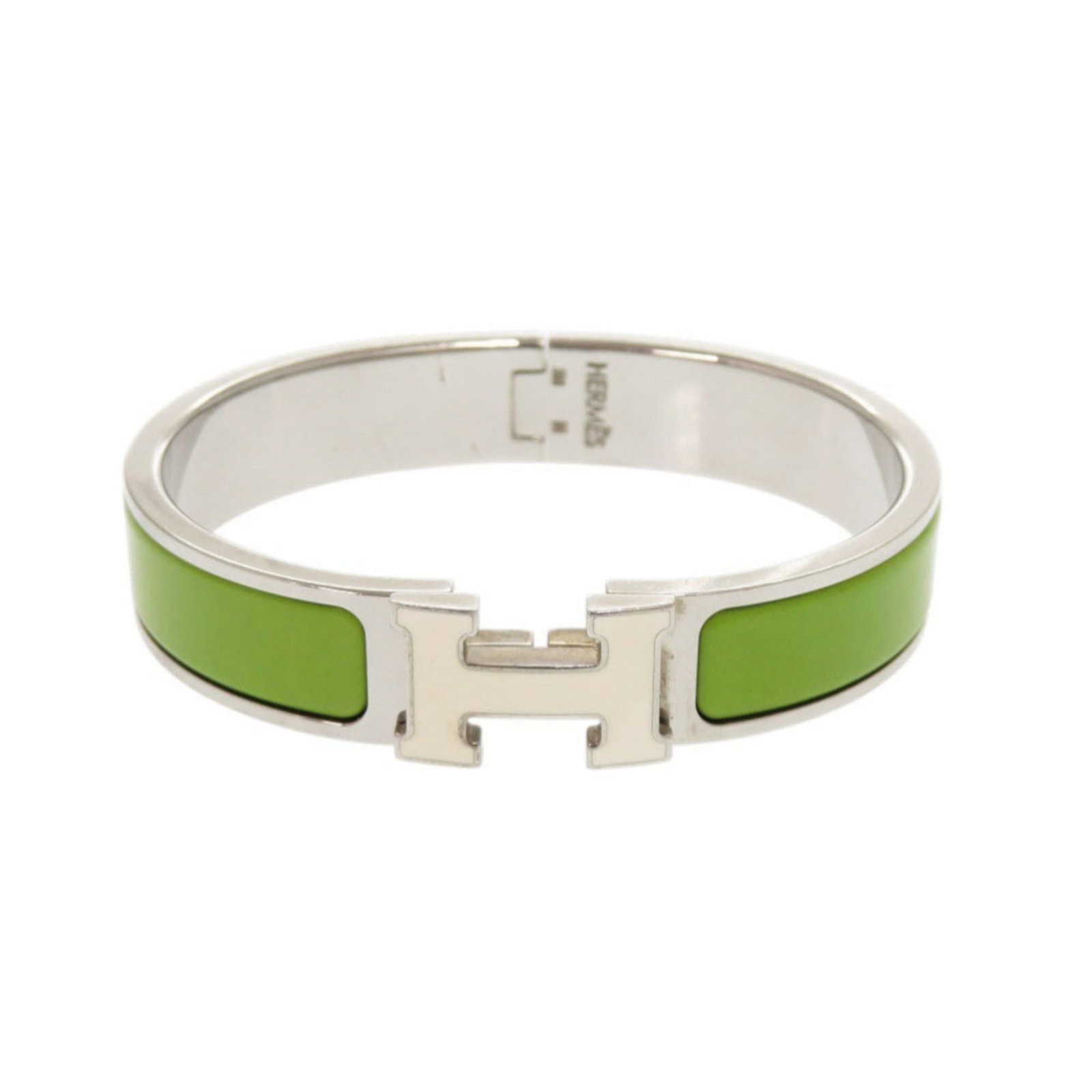 Hermes Metal Bangle: Hermes Metal Bangle A stunning Hermes metal bangle in vibrant green, adorned with intricate details and a touch of silver elegance. This pre-loved piece boasts its unique character with subtle scratch