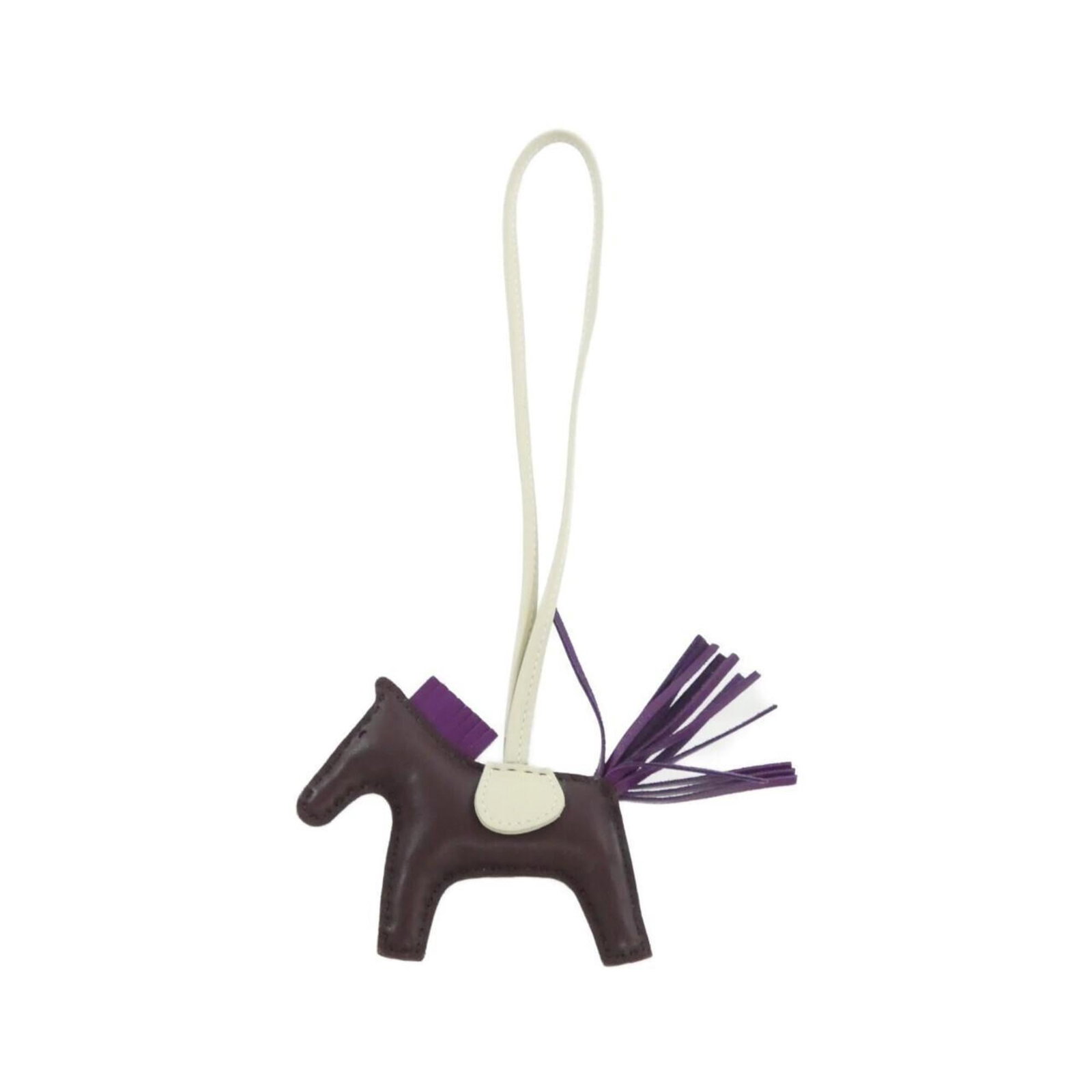Hermes Agneau Milo Handbag Charm: Hermes Agneau Milo Handbag Charm A stunning Hermes Agneau Milo Handbag Charm in rich violet hue, adding a touch of elegance to any bag. Made from luxurious Agneau Milo material, this charm boasts a sl