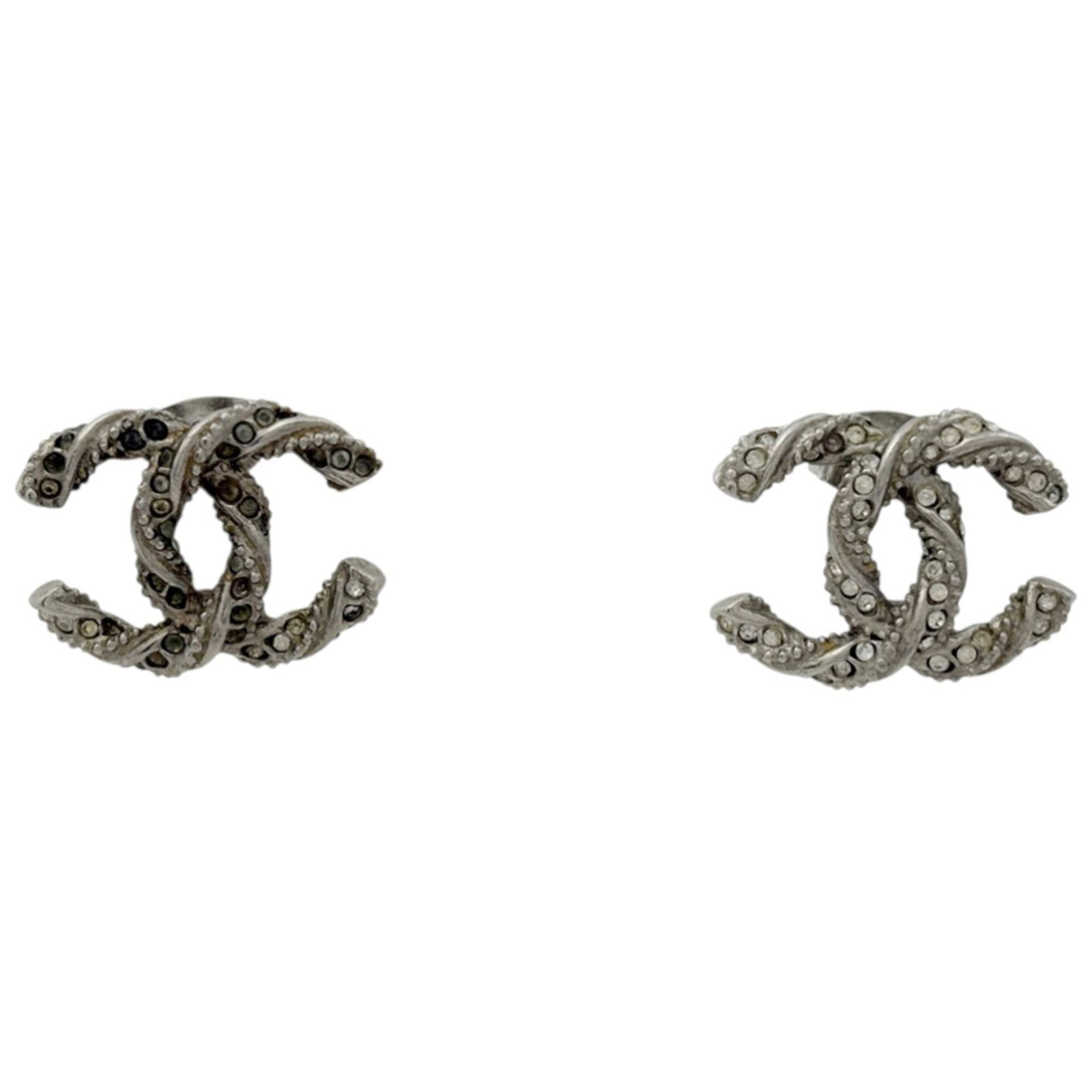 Earrings Chanel Stud: Earrings Chanel Stud Elevate your style with authentic Chanel stud earrings, featuring the iconic interlocking CC logo in sleek silver. With their timeless design and premium quality, these earrings a
