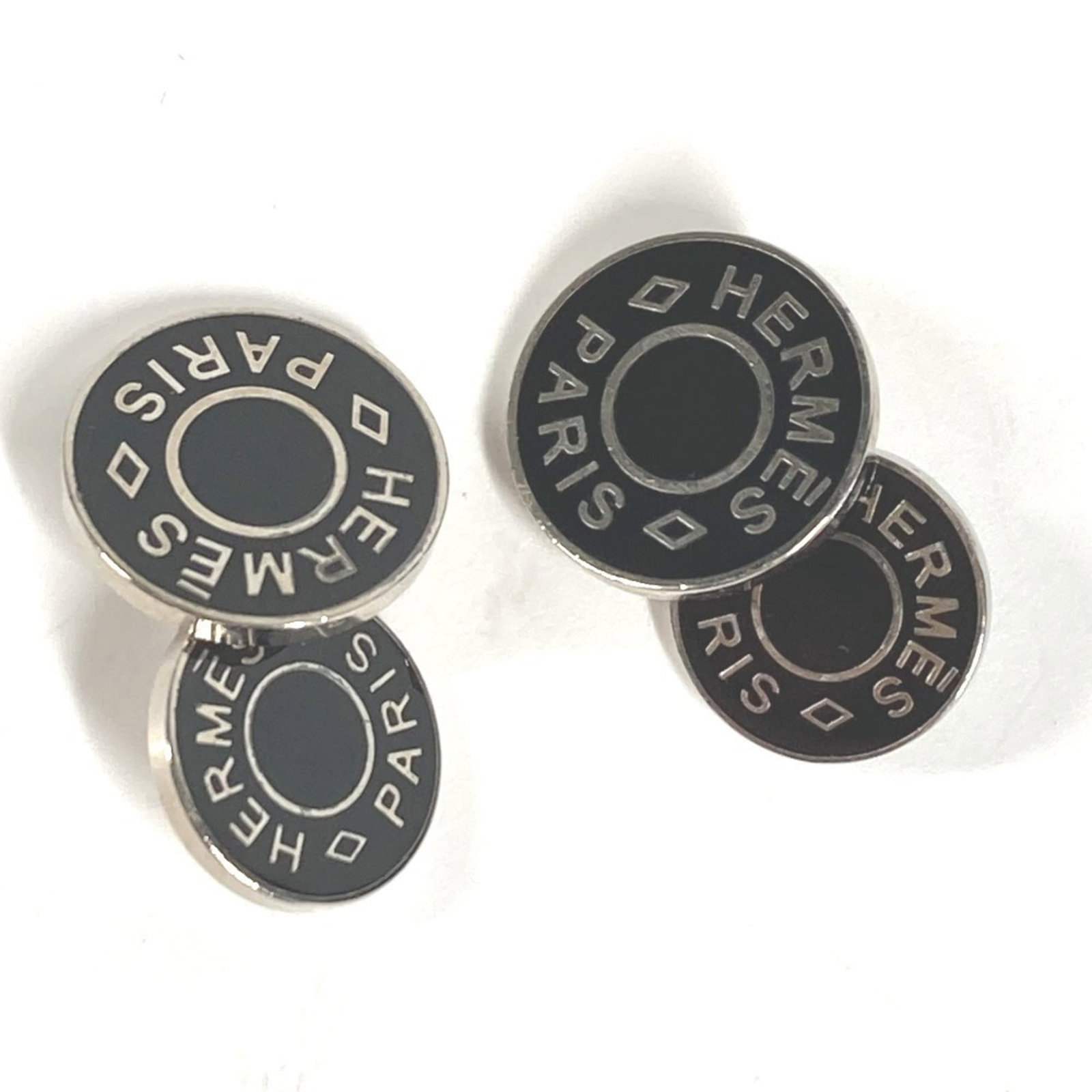 Hermes Metal Cufflinks: Hermes Metal Cufflinks Elevate your style with these luxurious Hermes metal cufflinks, crafted from high-quality metal and boasting a sleek black finish. With their classic design and subtle silver ac