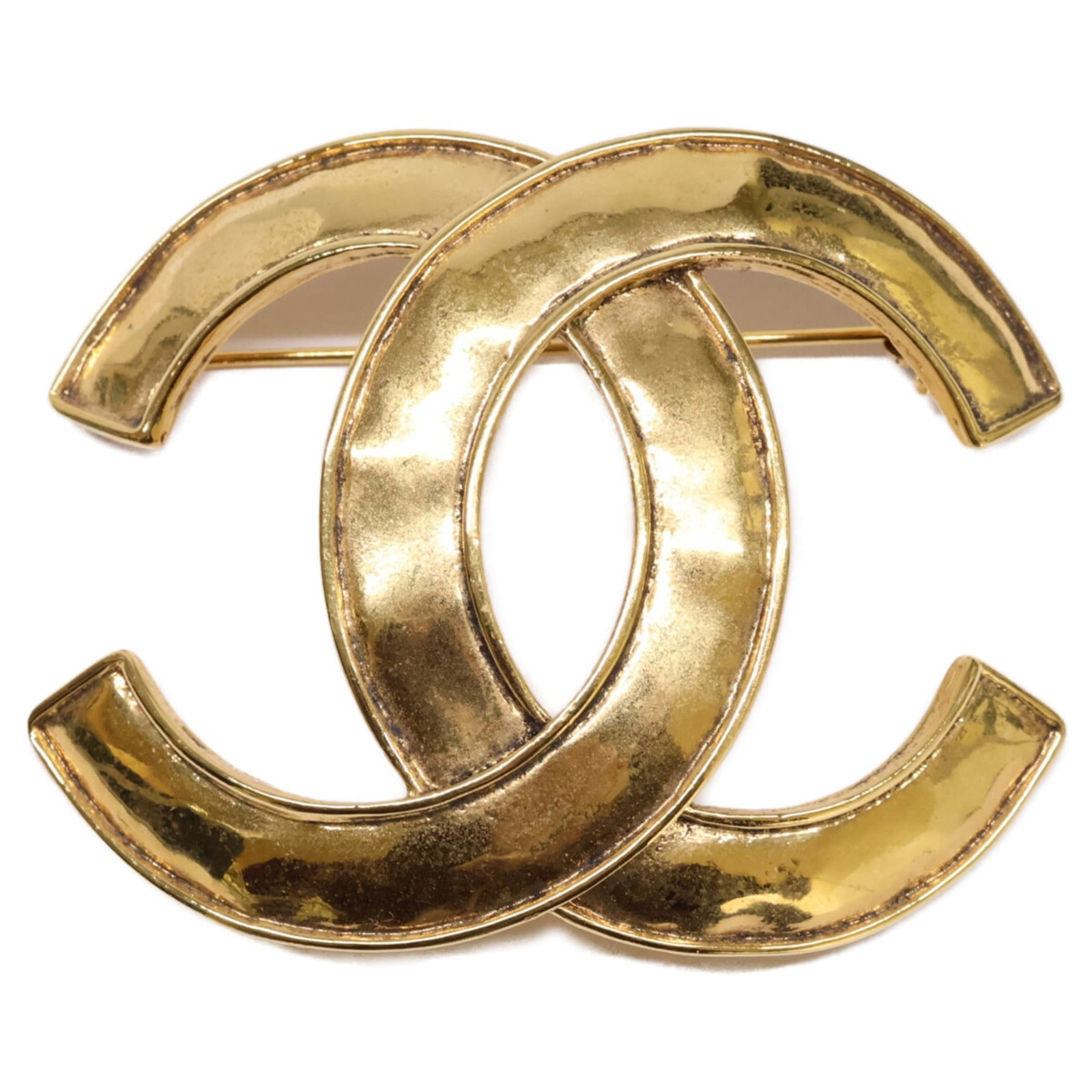 Chanel Brooch in Metal: Chanel Brooch in Metal A stunning Chanel brooch in gold metal, this elegant piece is perfect for adding a touch of luxury to any outfit. With its classic design and subtle scratches from years of wear