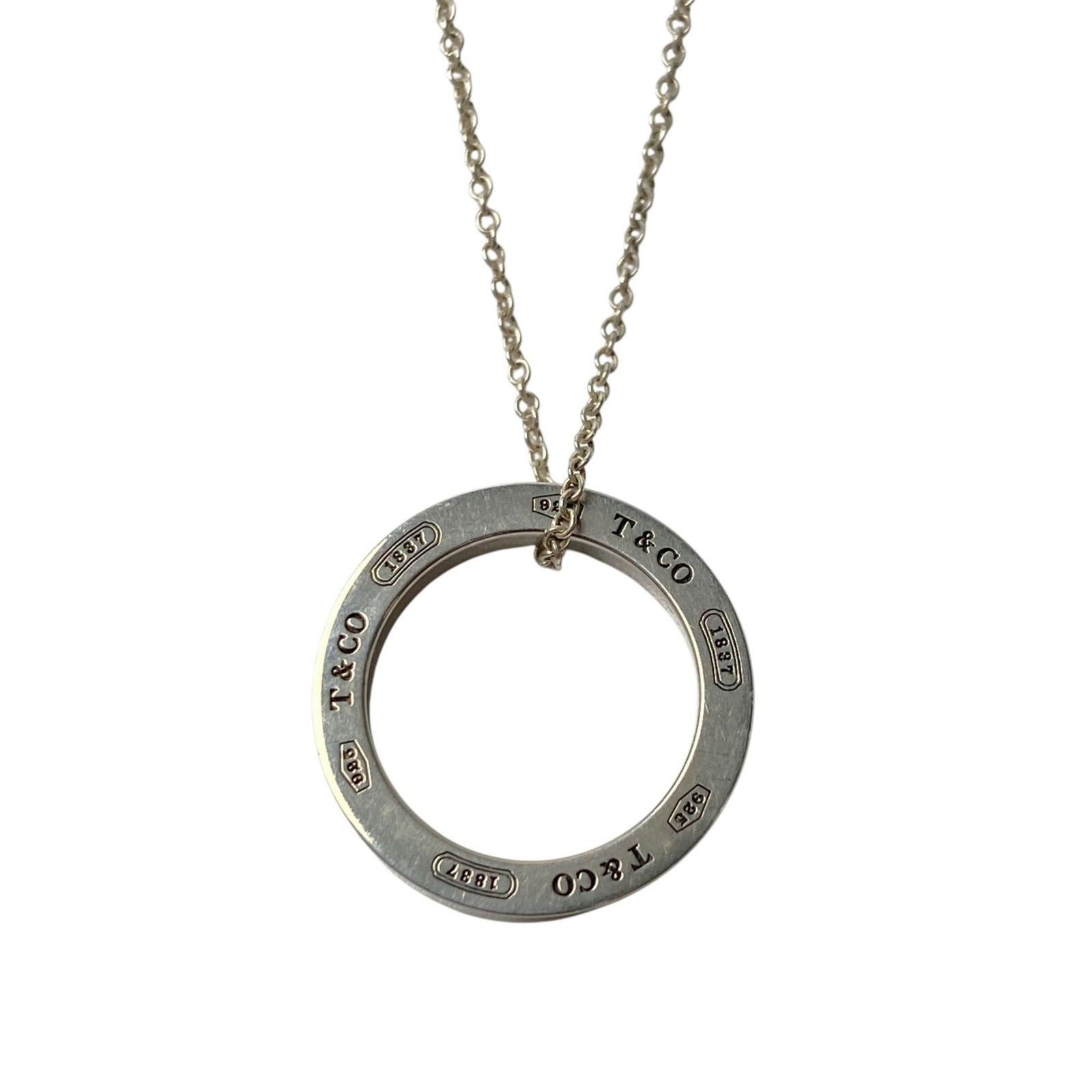 Ag925 Tiffany Women's 1837 Circle Ring Necklace in: Ag925 Tiffany Women's 1837 Circle Ring Necklace in A stunning piece of Tiffany history, the Ag925 Circle Ring Necklace is a timeless classic that exudes elegance and sophistication. With its sterling