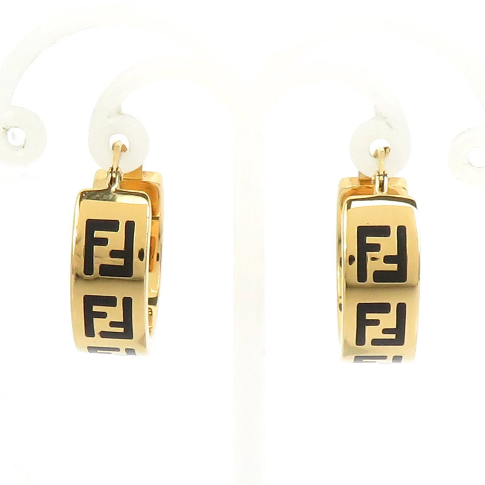 Fendi Hoop Earrings in Metal: Fendi Hoop Earrings in Metal Elevate your style with the iconic Fendi hoop earrings, crafted from luxurious metal and boasting a sleek gold finish that adds a touch of sophistication to any outfit. Wi