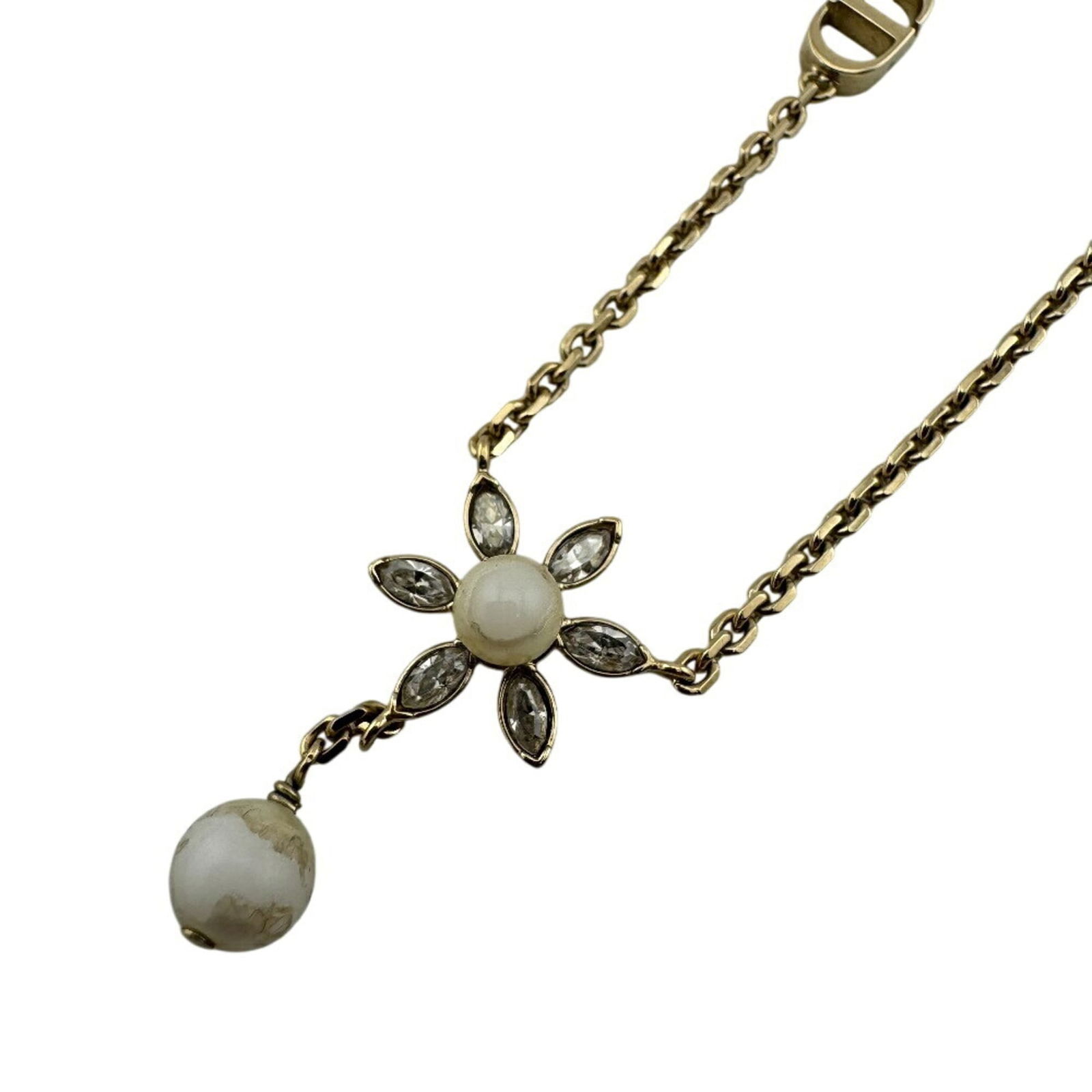 Christian Dior Gold Necklace with Flower Motif Chain: Christian Dior Gold Necklace with Flower Motif Chain Elevate your elegance with the iconic Christian Dior gold necklace, boasting a delicate flower motif chain that adds a touch of sophistication to a