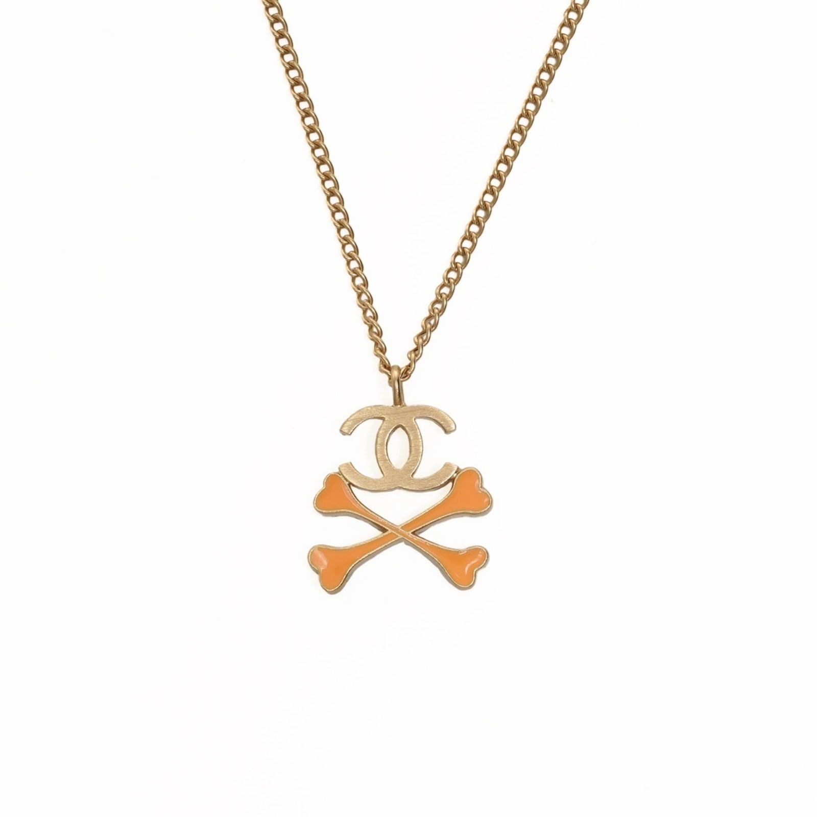 Chanel 03P 2003 Coco Crossbone Mark Necklace in Gold: Chanel 03P 2003 Coco Crossbone Mark Necklace in Gold A stunning Chanel Coco Crossbone Mark Necklace in gold, this 2003 piece boasts the iconic interlocking CC logo that has become synonymous with luxu