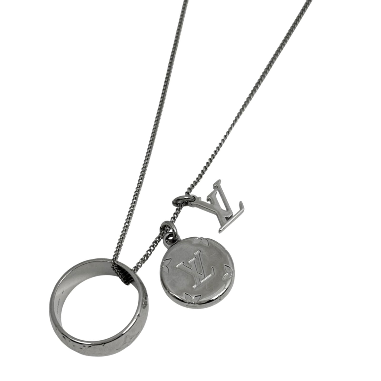 Louis Vuitton Monogram Ring Necklace for Women in Silver: Louis Vuitton Monogram Ring Necklace for Women in Silver Elevate your style with the iconic Louis Vuitton Monogram Ring Necklace, crafted in sleek silver metal and adorned with the signature LV monogr