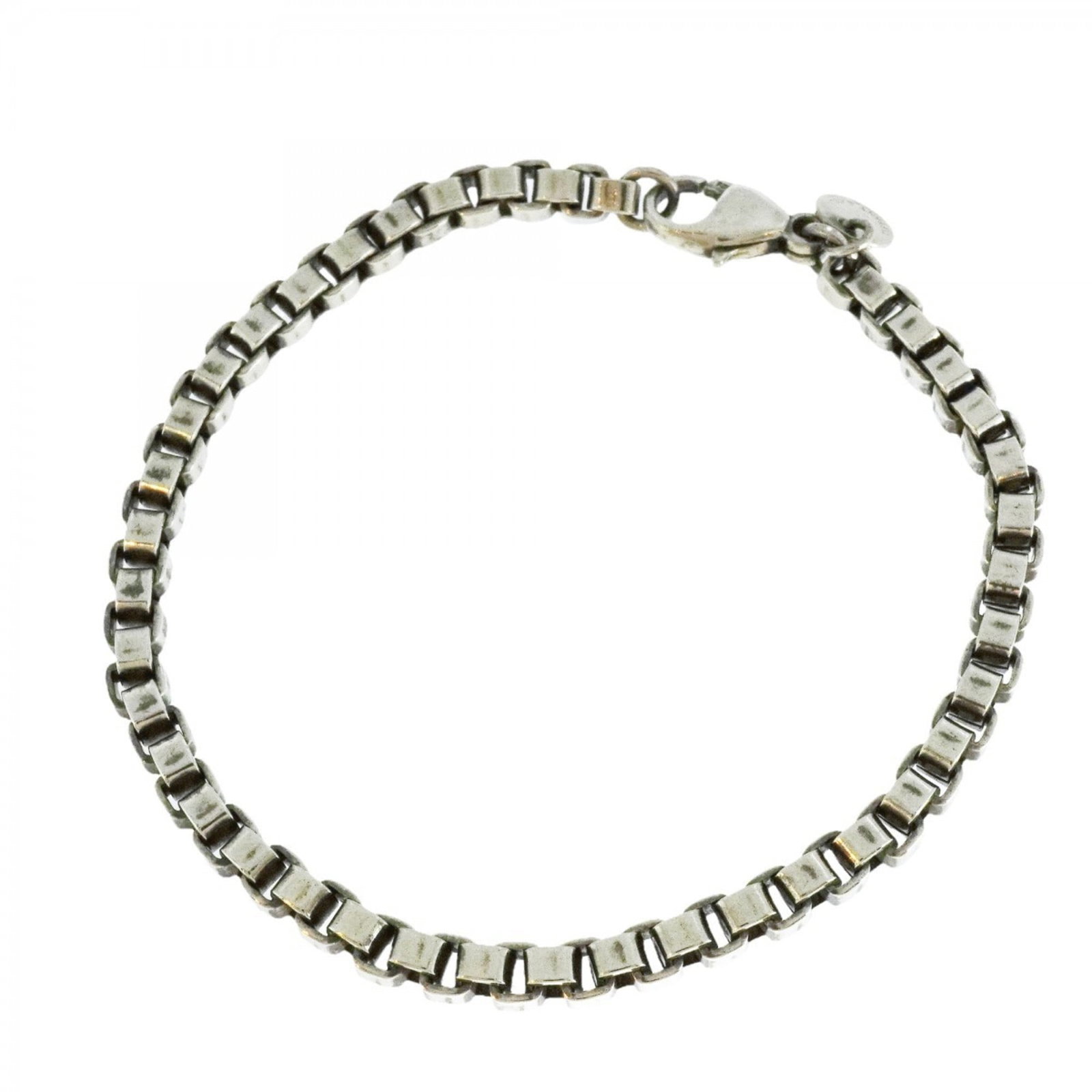 925 Tiffany Charm Bracelet Silver: 925 Tiffany Charm Bracelet Silver A beautiful 925 Tiffany charm bracelet in excellent condition, with its silver tone still shining through despite some minor signs of wear and tear from everyday use.