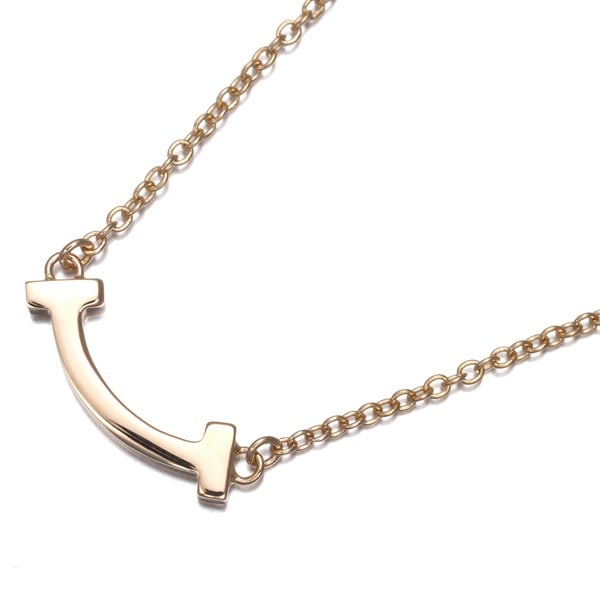 Gold Tiffany&Co. Necklace Tiffany T Smile Mini 18K 750 Rose: Gold Tiffany&Co. Necklace Tiffany T Smile Mini 18K 750 Rose Elevate your elegance with the stunning Tiffany T Smile Mini necklace, crafted from 18k rose gold and boasting a delicate, dainty design tha