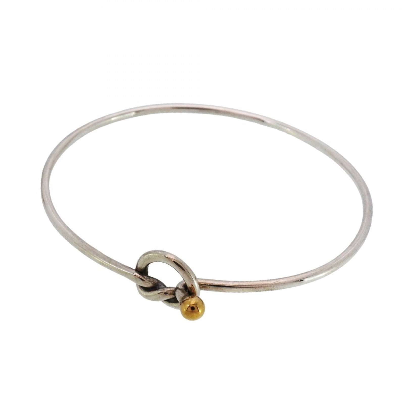 Yellow Gold (18K) - Tiffany Bangle Silver 925: Yellow Gold (18K) - Tiffany Bangle Silver 925 A stunning Tiffany bangle in 18K yellow gold and sterling silver, this classic piece boasts a timeless design that exudes elegance. With its 16.5cm length