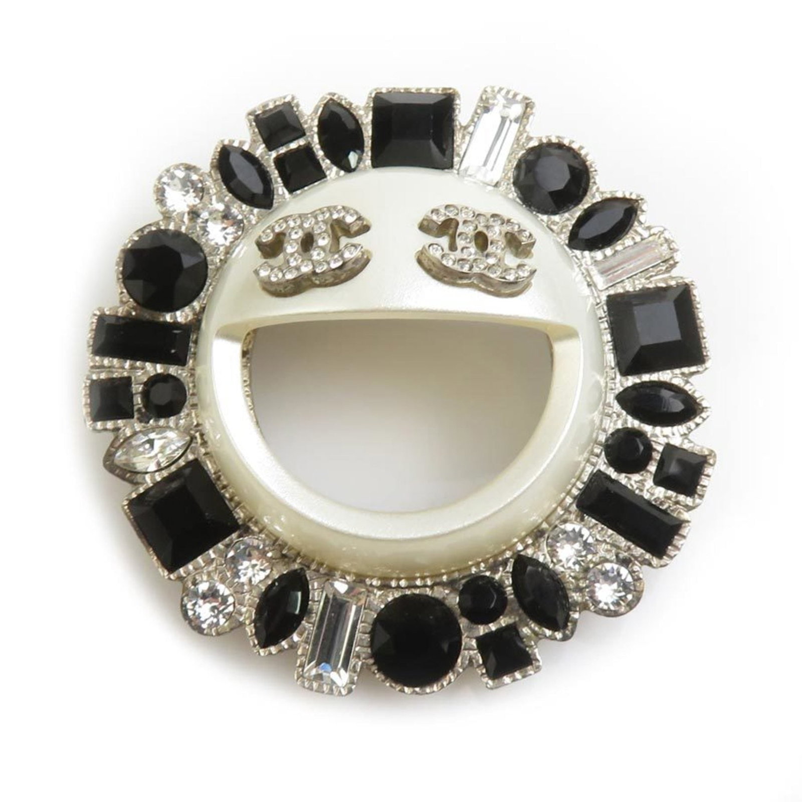 Rhinestone - Chanel Brooch Metal: Rhinestone - Chanel Brooch Metal Add a touch of luxury to your wardrobe with this stunning Chanel brooch, adorned with intricate rhinestones and metal details in sleek silver and black hues. The 4.6cm