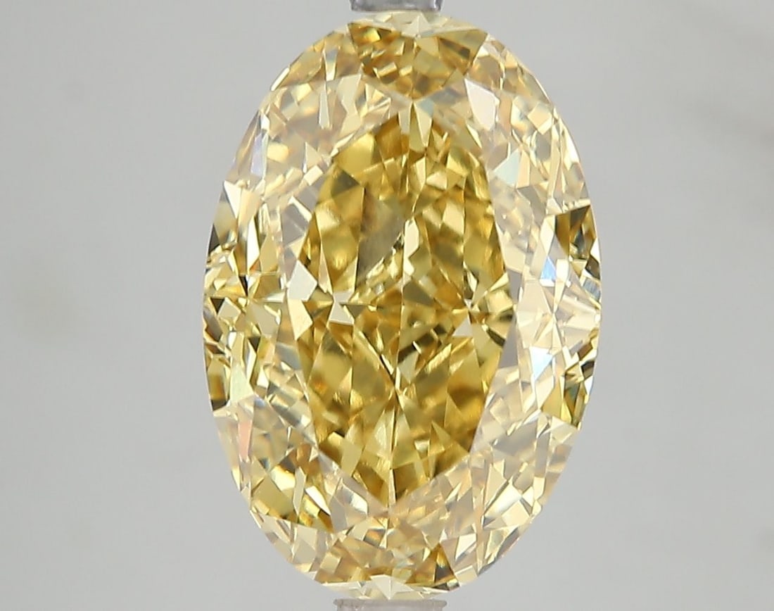 IGI Oval 6.15ct Fancy Vivid Yellow VVS2 Loose Lab Diamond: IGI Oval 6.15ct Fancy Vivid Yellow VVS2 Loose Lab Diamond Experience the radiant beauty of nature in a lab-grown diamond, certified by IGI as Fancy Vivid Yellow with exceptional clarity and cut. This