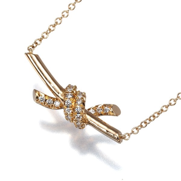 Tiffany & Co. 18k Rose Gold Diamond Knot Necklace: Tiffany & Co. 18k Rose Gold Diamond Knot Necklace Elevate your elegance with the Tiffany & Co. 18k Rose Gold Diamond Knot Necklace, where natural beauty meets timeless sophistication. This exquisite p