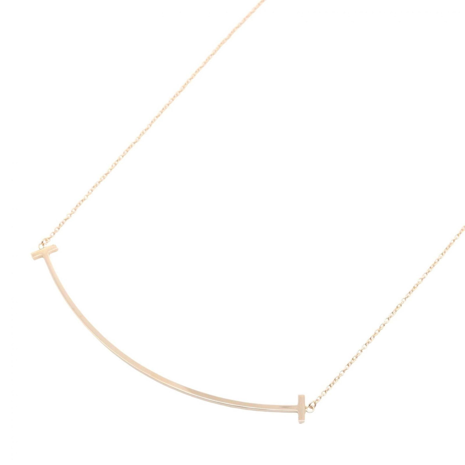 Tiffany & Co. 18k Yellow Gold Women's Large T Smile Necklace: Tiffany & Co. 18k Yellow Gold Women's Large T Smile Necklace Elevate your elegance with the iconic Tiffany & Co. 18k Yellow Gold Women's Large T Smile Necklace, boasting a stunning 5mm x 70mm pendant