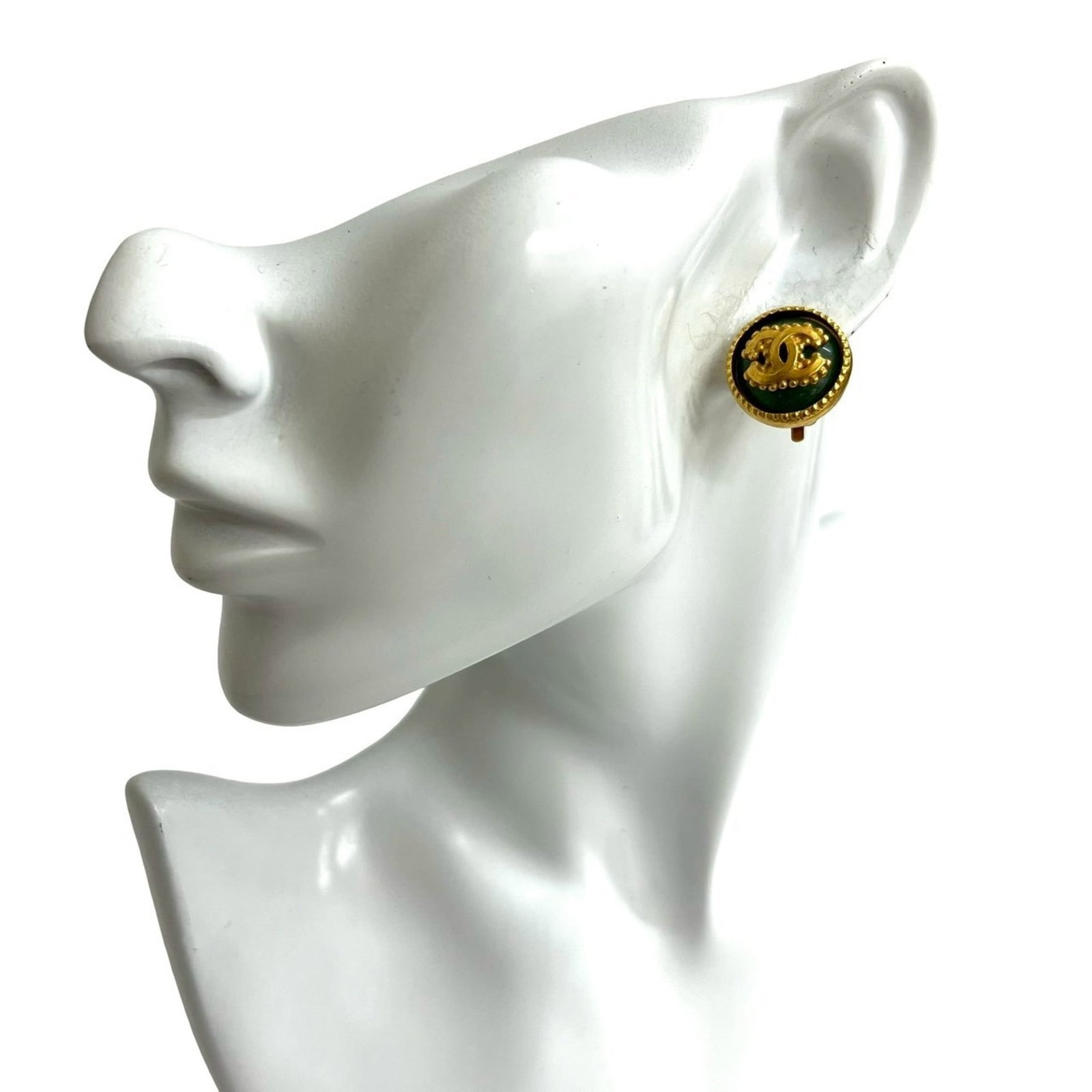 Chanel Clip Earrings in Gold Plating: Chanel Clip Earrings in Gold Plating Add a touch of timeless elegance to your outfit with these stunning Chanel clip earrings in gold plating. Featuring the iconic interlocking CC logo, these earrings