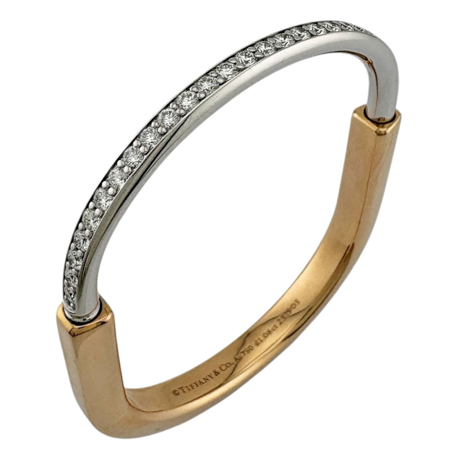 Pink Gold 18K Tiffany Bangle: Pink Gold 18K Tiffany Bangle Elevate your style with the iconic Tiffany pink gold 18K bangle, boasting a delicate 1.08ct diamond set in a slender, 6mm wide band that shimmers against your skin. This e