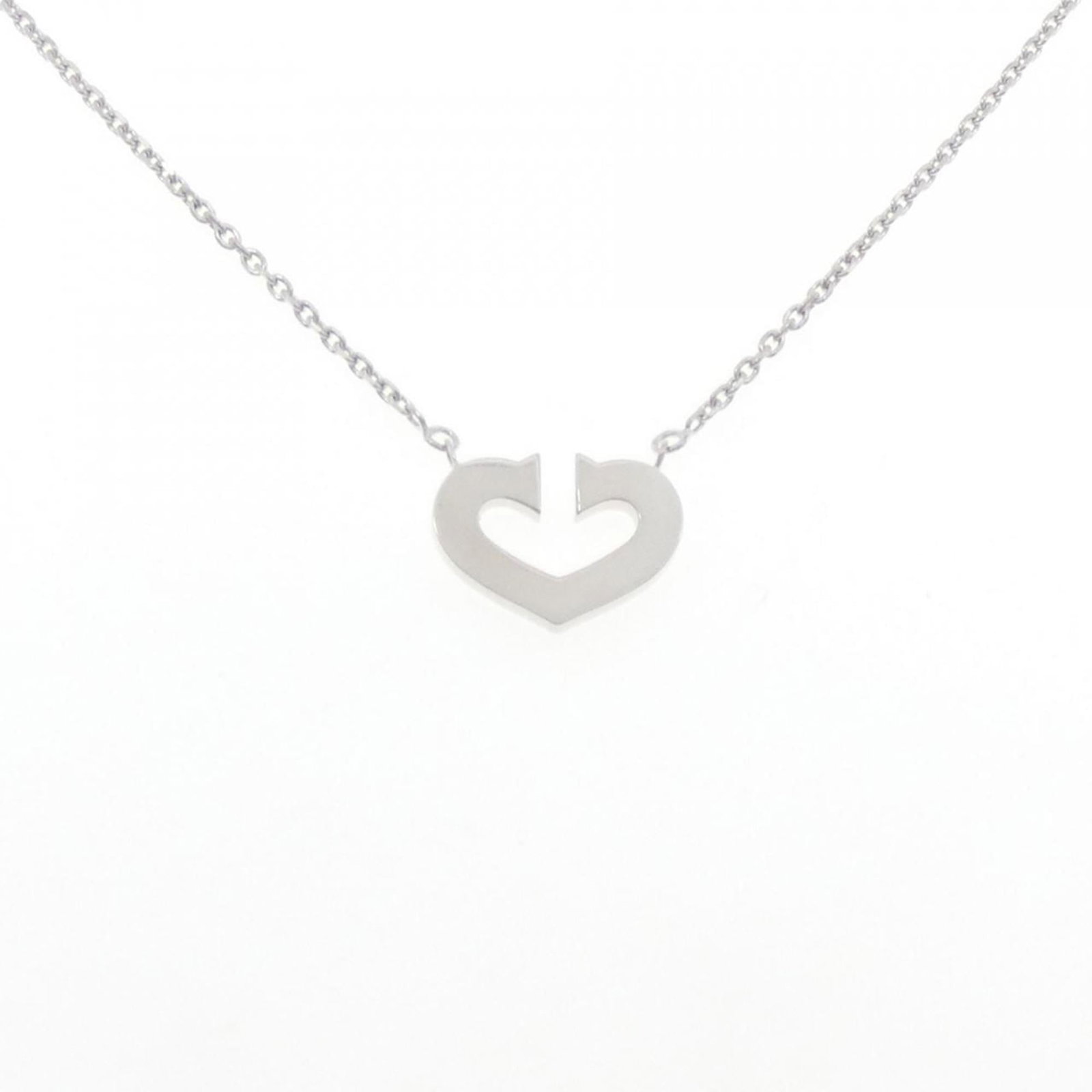 Cartier C-Heart Necklace: Cartier C-Heart Necklace A stunning Cartier C-Heart Necklace, crafted from 18K white gold, boasts a sleek and modern design that exudes elegance. This timeless piece is perfect for adding a touch of s