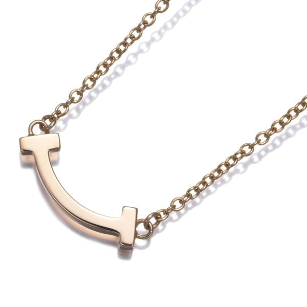 Gold Tiffany&Co. Necklace Tiffany T Smile Mini 18K 750 Rose: Gold Tiffany&Co. Necklace Tiffany T Smile Mini 18K 750 Rose Elevate your elegance with the stunning Tiffany T Smile Mini necklace, crafted from 18k rose gold and boasting a delicate, dainty design tha