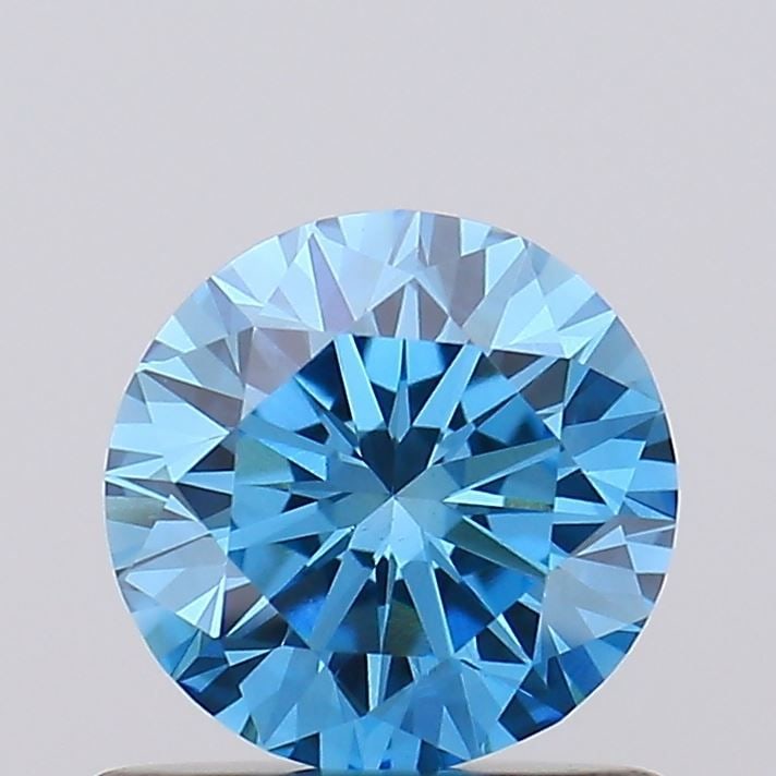 IGI Round 0.76ct Fancy Vivid Blue VVS2 Diamond: IGI Round 0.76ct Fancy Vivid Blue VVS2 Diamond Experience the breathtaking beauty of a Fancy Vivid Blue diamond, one of the rarest and most coveted colors in nature. This exquisite 0.76ct lab-grown