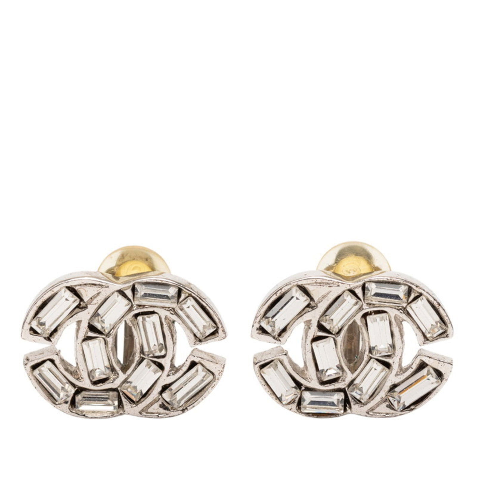 Chanel Clip Earrings in Metal: Chanel Clip Earrings in Metal Add a touch of timeless elegance to your outfit with these stunning Chanel clip earrings in silver metal, adorned with sparkling rhinestones that catch the light. With th