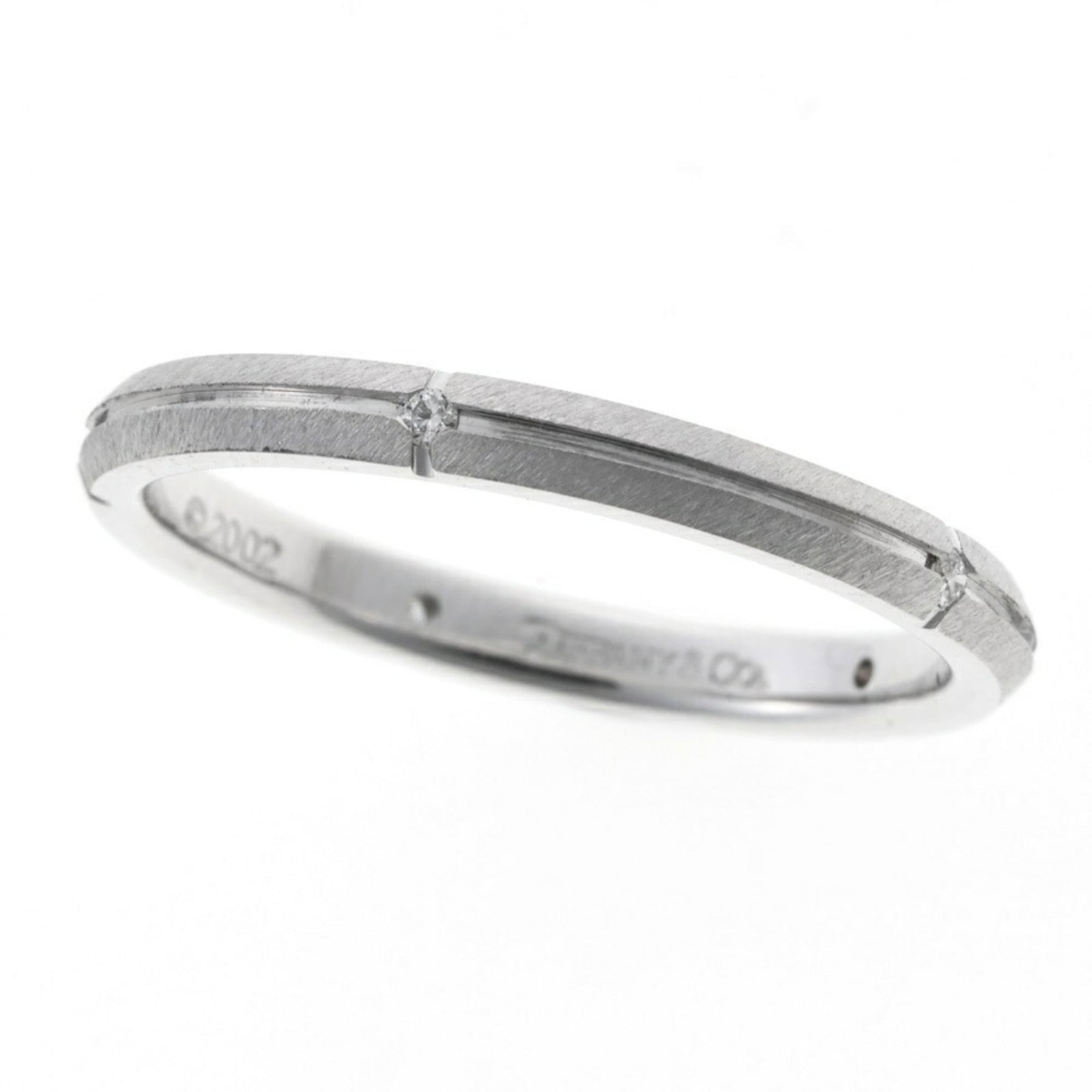 (18K) Tiffany Band Ring White Gold: (18K) Tiffany Band Ring White Gold A stunning 18K white gold band ring from Tiffany, perfect for the discerning gentleman. With its sleek design and high-quality craftsmanship, this piece is a timeles