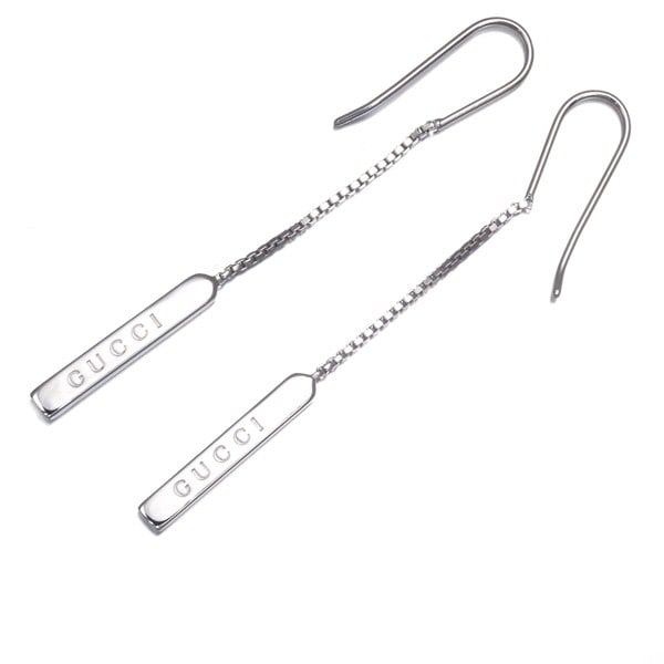 Gucci 18k White Gold Lariat Earrings with Logo Bar: Gucci 18k White Gold Lariat Earrings with Logo Bar Elevate your style with these stunning 18k white gold lariat earrings from Gucci, adorned with the iconic logo bar that adds a touch of luxury to any