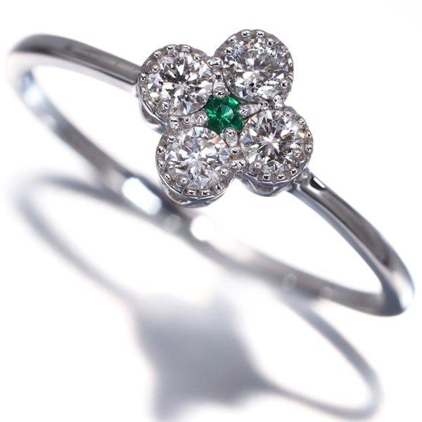 Gold Emerald 0.03Ct Diamond 0.23Ct Flower Ring 18K 750 White: Gold Emerald 0.03Ct Diamond 0.23Ct Flower Ring 18K 750 White Elevate your style with this stunning 18k white gold ring, boasting a vibrant 0.03ct diamond surrounded by an emerald main stone of 0.23ct.