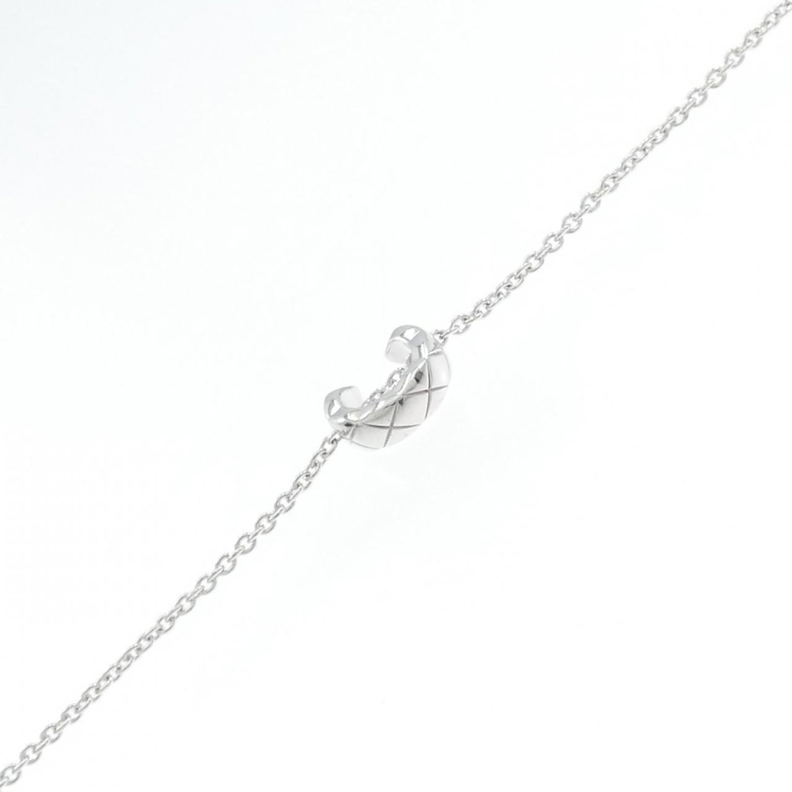 Chanel 18k White Gold Charm Bracelet: Chanel 18k White Gold Charm Bracelet Elevate your style with this exquisite 18k white gold charm bracelet from Chanel, boasting a sleek and sophisticated design that exudes luxury. With its durable co