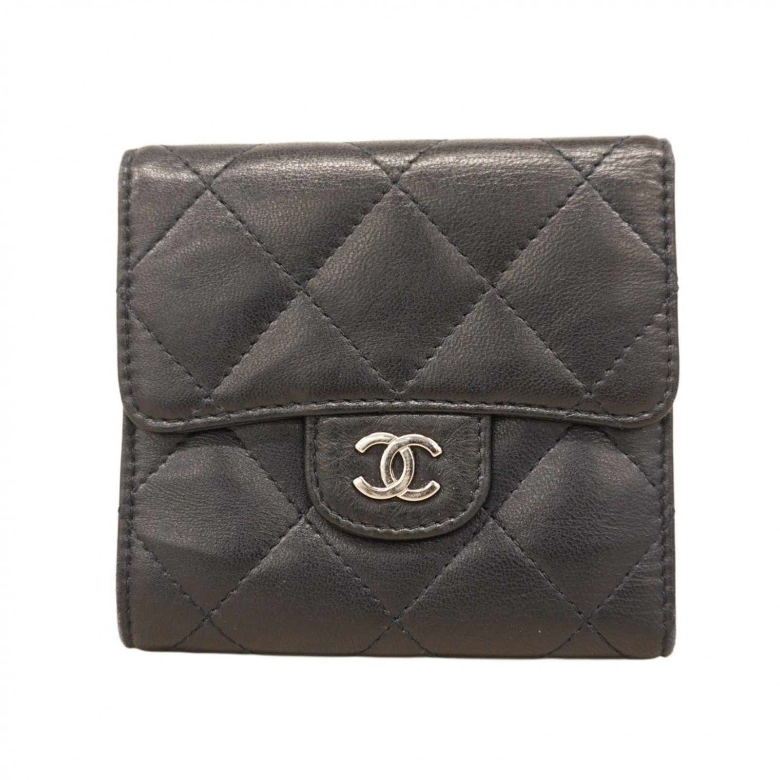 Chanel Tri-Fold Leather Wallet: Chanel Tri-Fold Leather Wallet A timeless piece of luxury, this Chanel tri-fold leather wallet exudes elegance with its classic design and premium lambskin material. With its navy color and compact si